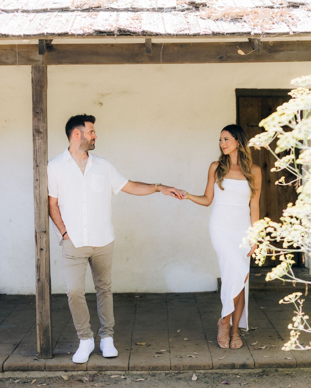 Couple holding hands on a tree-lined path, lifestyle couples session by Makenzie Rae Photography, Orange County California photographer.