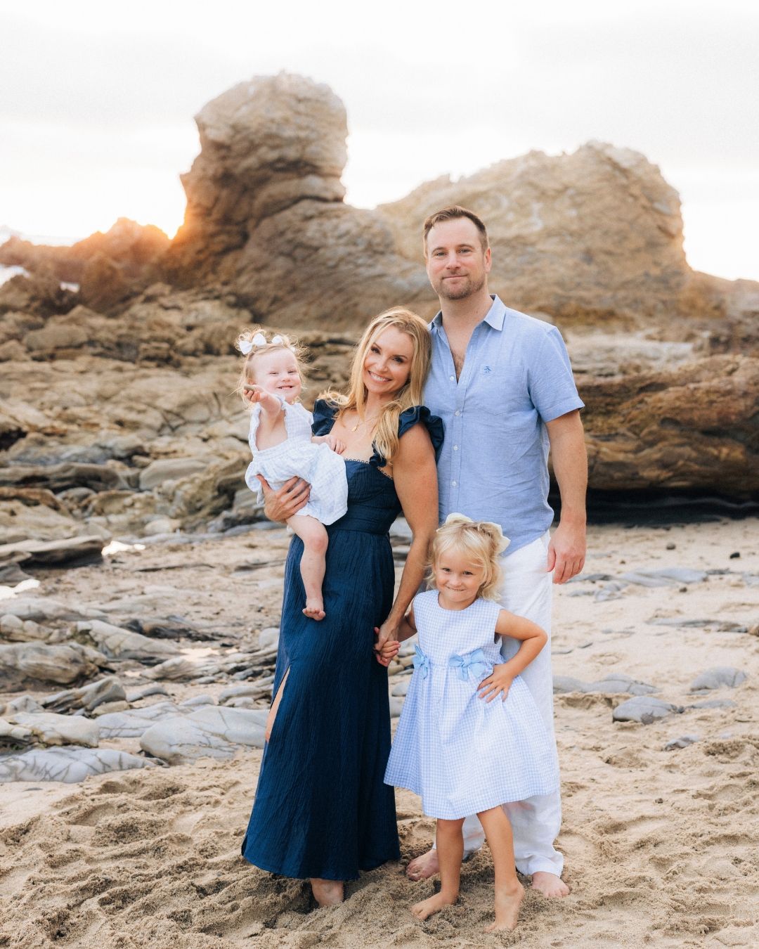 Family with children enjoying an outdoor photo session on the Southern California coast by Makenzie Rae Photography, OC