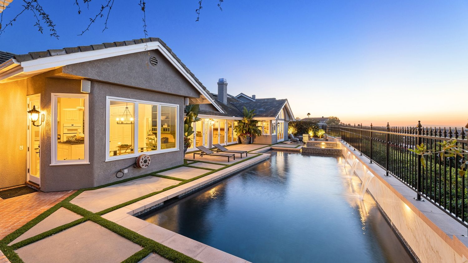 Luxury home exterior with pool at sunset, real estate photography by Makenzie Rae Photography, Irvine California photographer.
