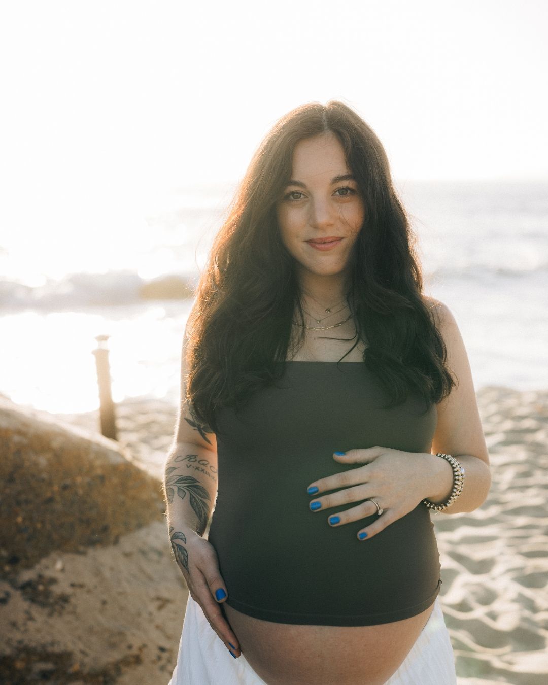 Maternity photos for pregnant woman at the beach in Orange County, California with Makenzie Rae Photography
