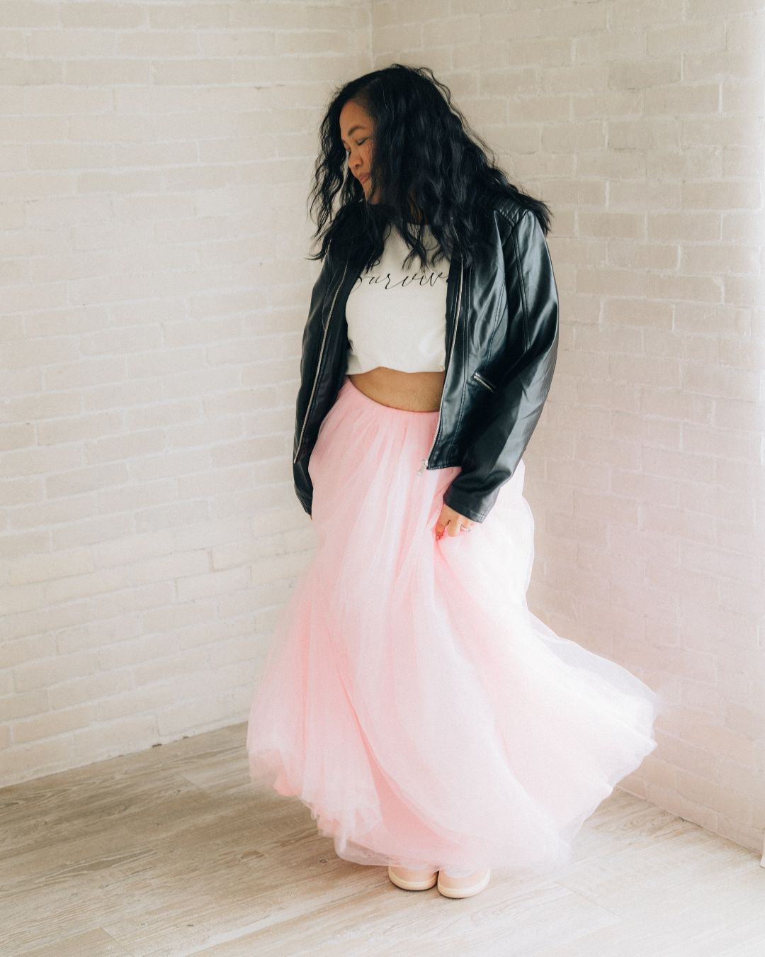 Woman in a flowing pink tulle skirt twirling during a lifestyle portrait session in Orange County, photographed by Makenzie Rae Photography.
