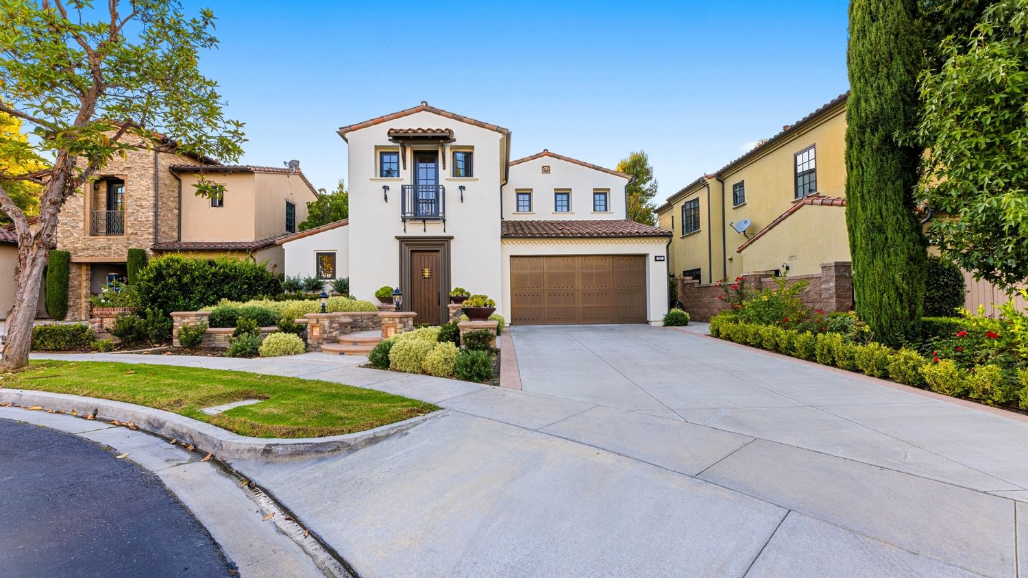Luxury home exterior with driveway and landscaping, real estate photography by Makenzie Rae Photography, Orange County California photograph