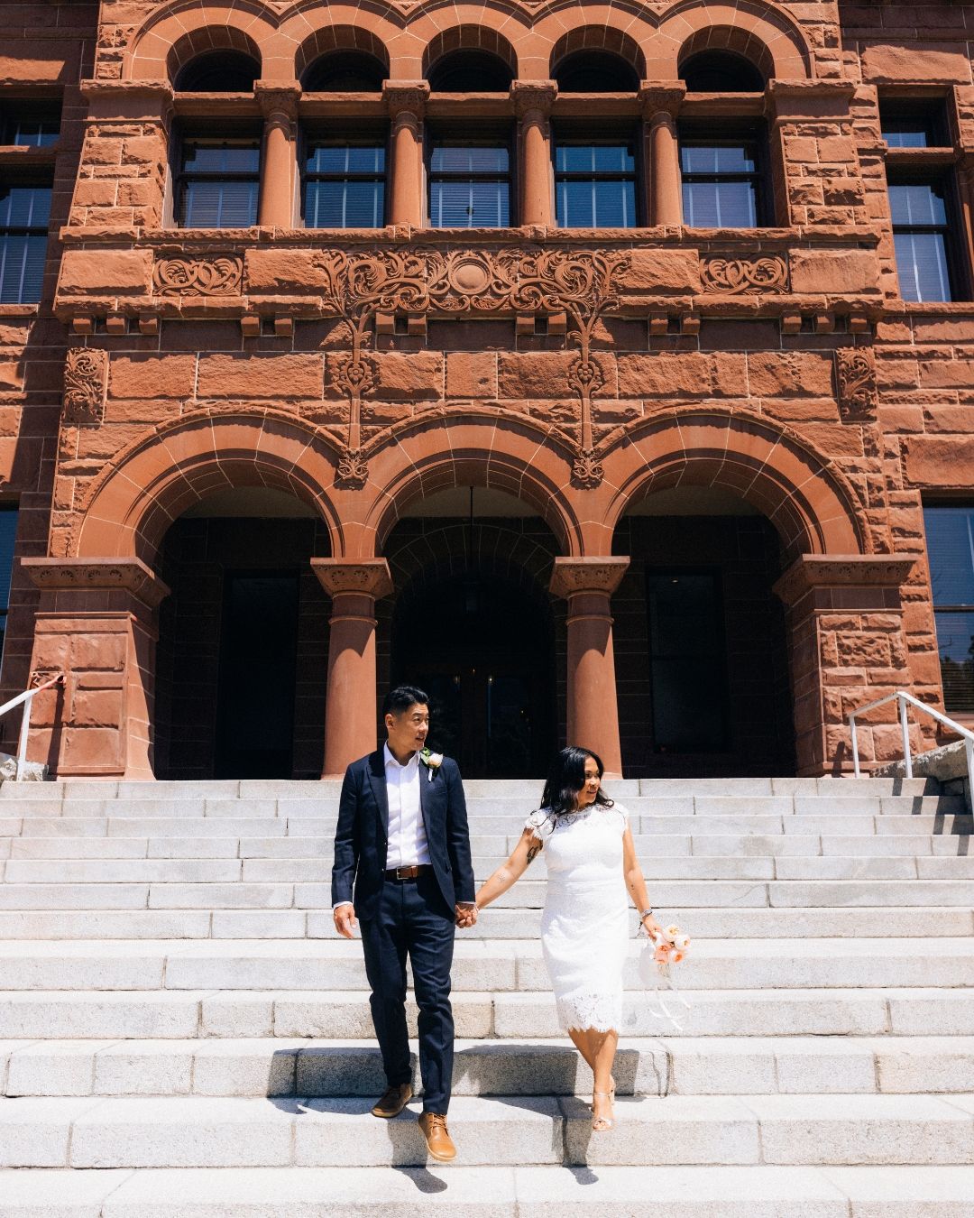 Couple walking the steps after getting married, wedding photography by makenzie rae photo