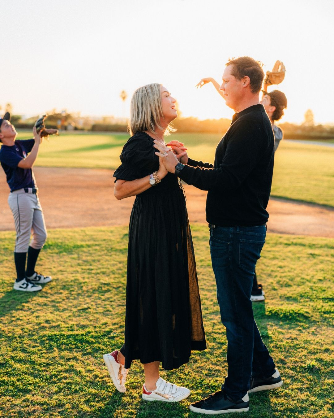 Family portrait at the baseball field, photographed by Makenzie Rae Photography, Orange County California couples photographer