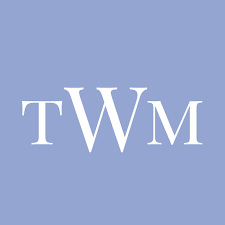 TWM monogram logo in elegant serif font on a soft periwinkle blue background.