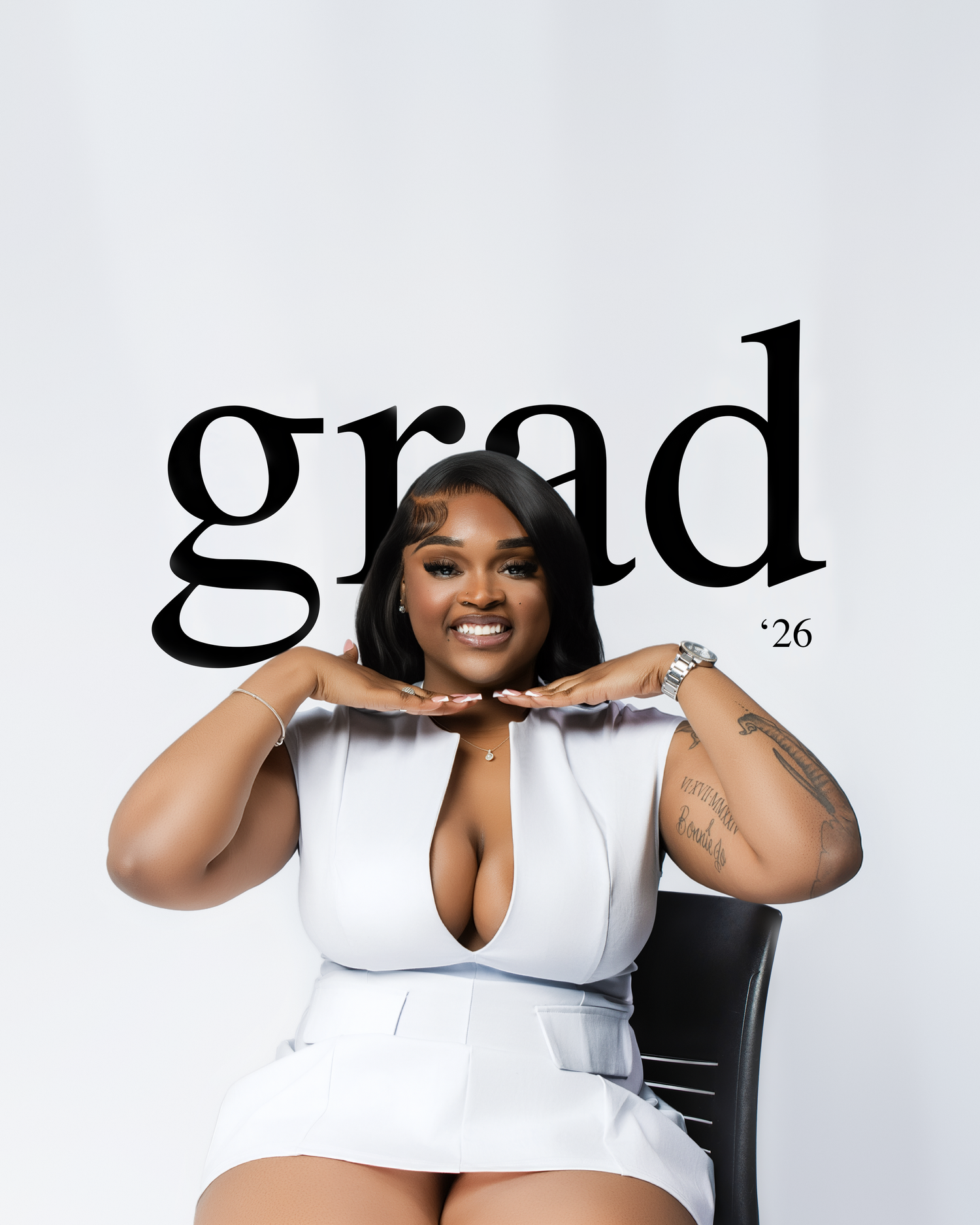 A young woman in a white dress poses confidently in a chair with bold grad 26 text behind her.