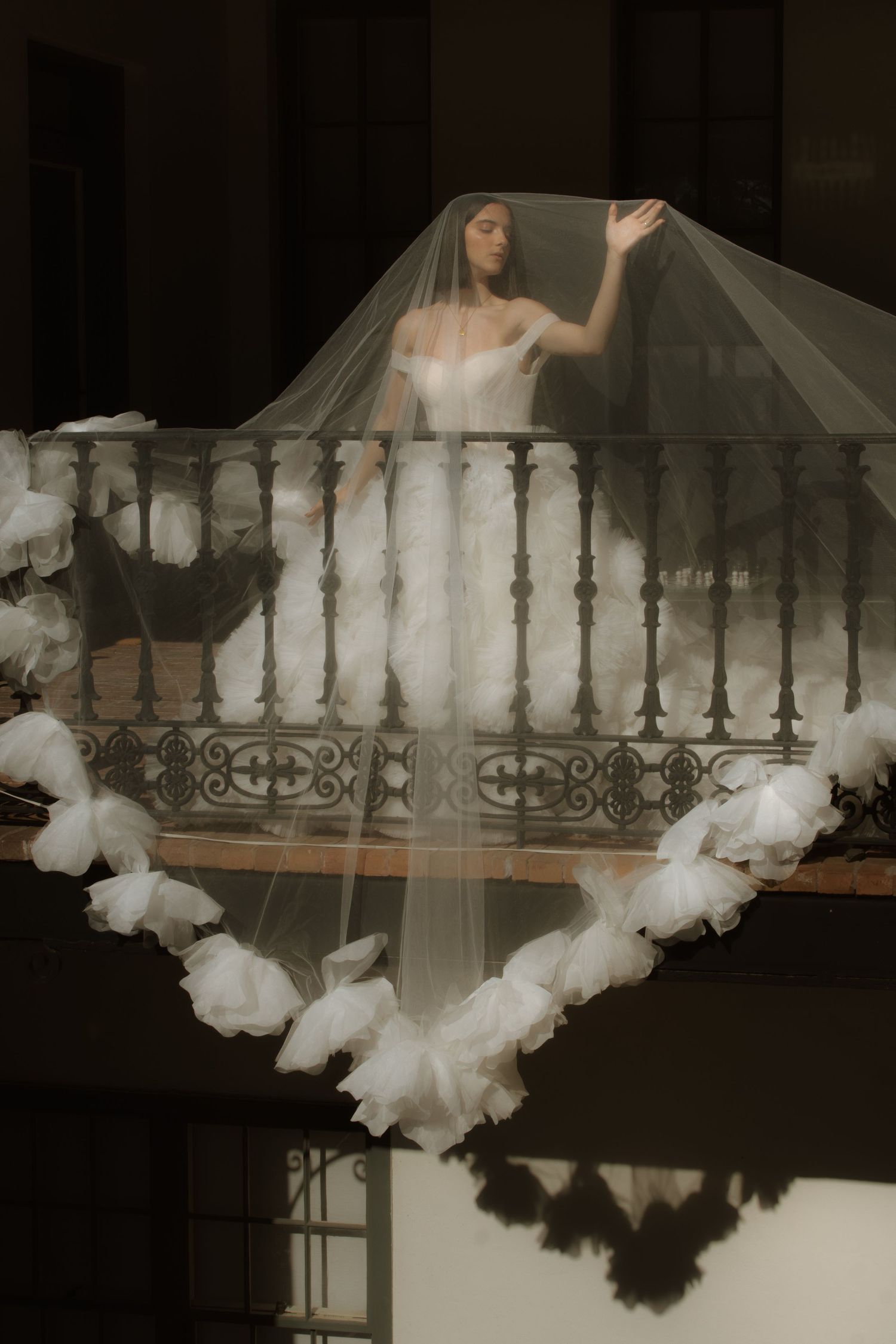 A series of artistic photographs showing white smoke or fog effects against ornate white balcony railings in dim lighting.
