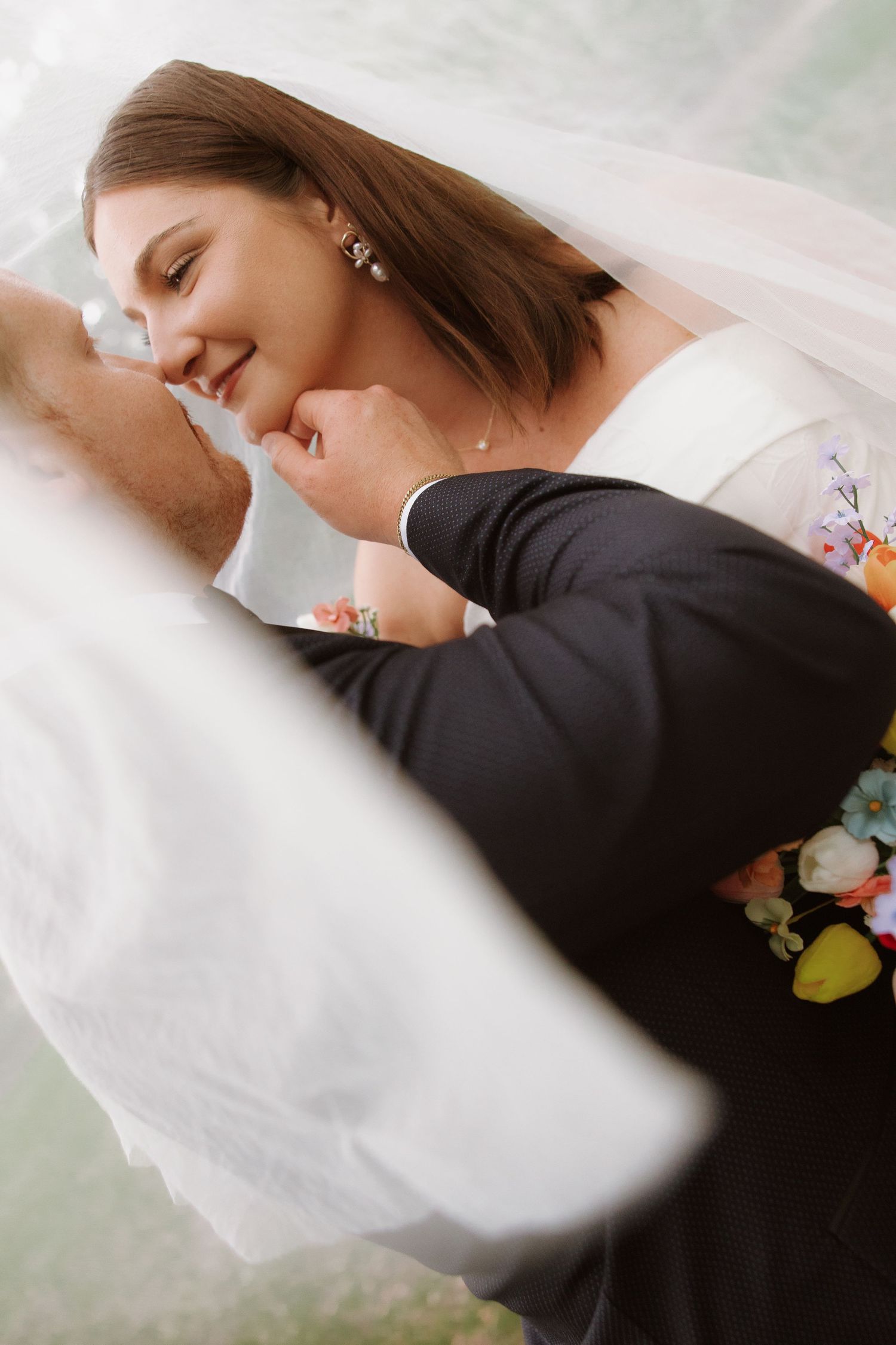 A close-up detail shot showing a couple embracing in a romantic dance pose with soft dreamy focus.