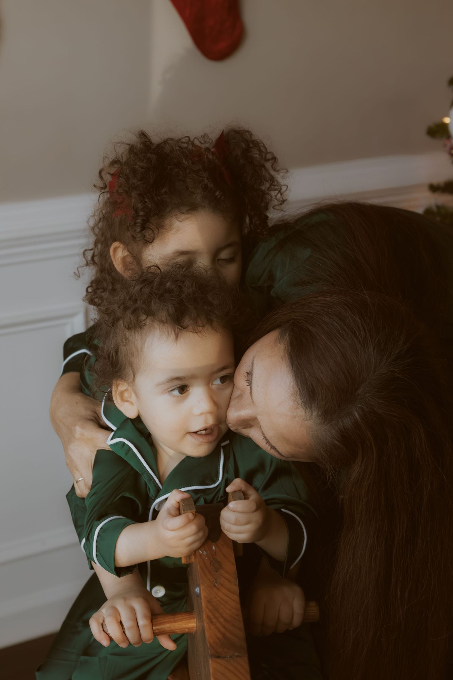 An intimate family moment shared on a couch with cuddles and laughter.