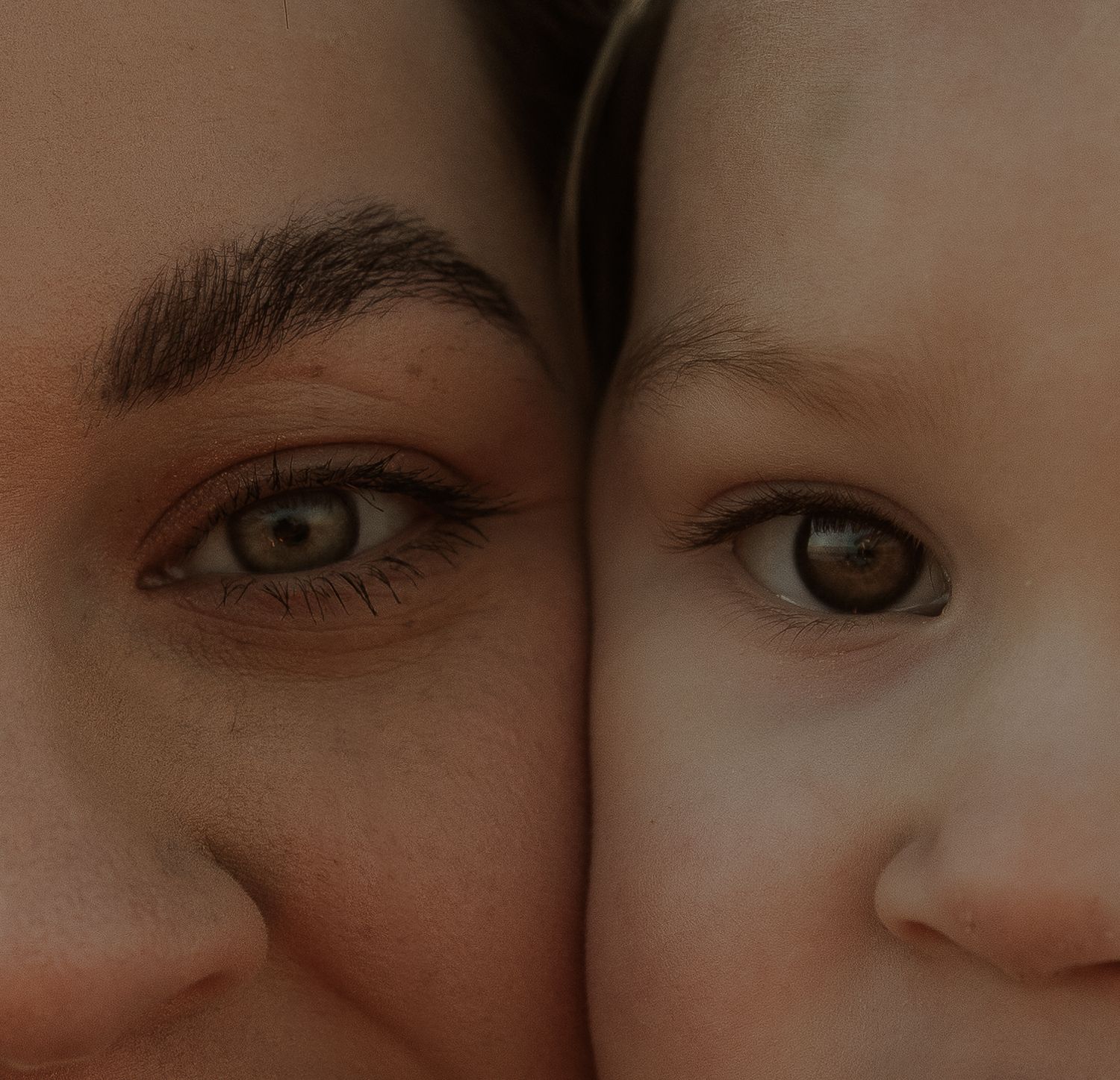 Close-up artistic photograph showing two eyes side by side in warm tones.