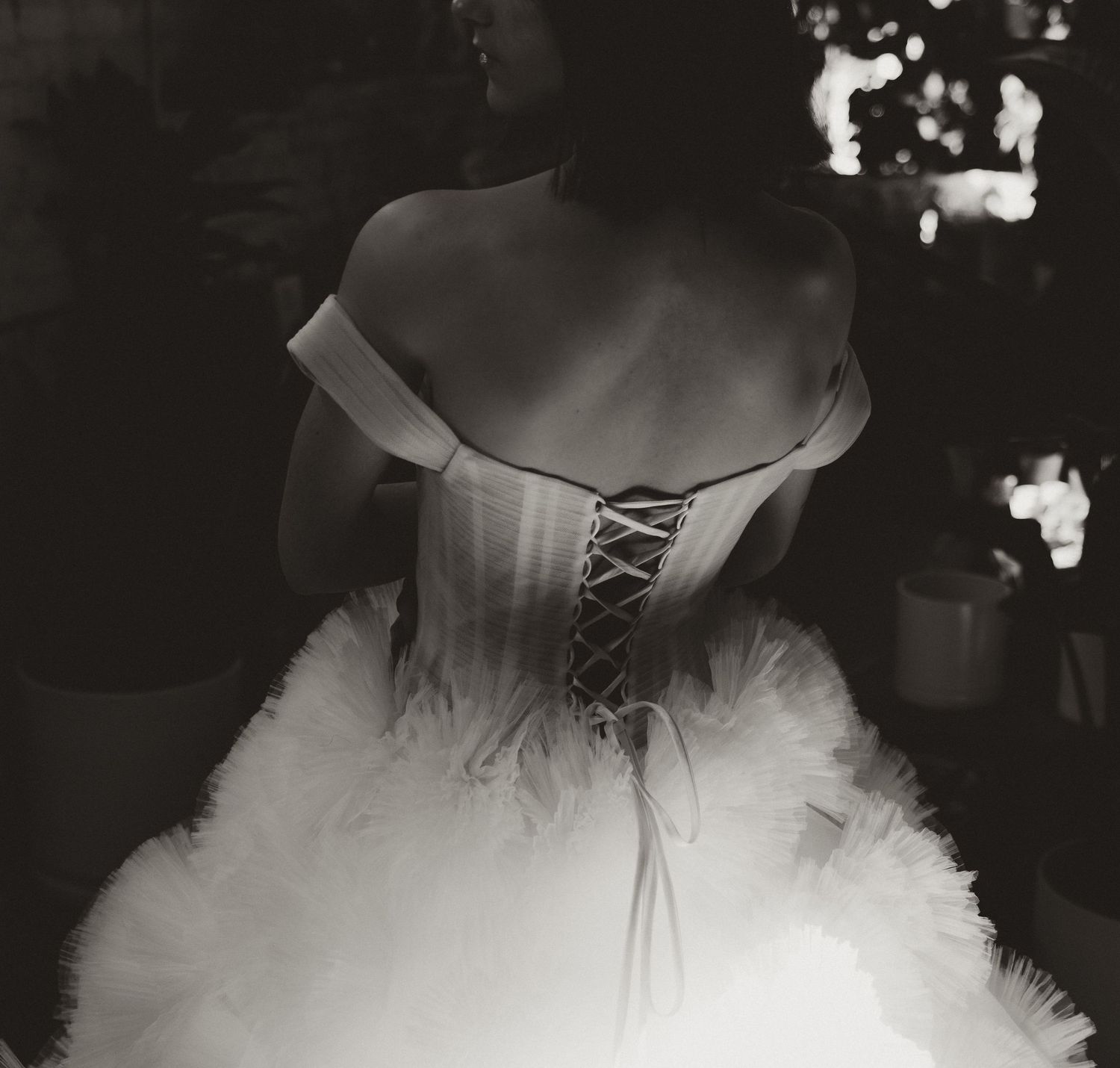 Black and white artistic shot of a corseted wedding dress bodice.