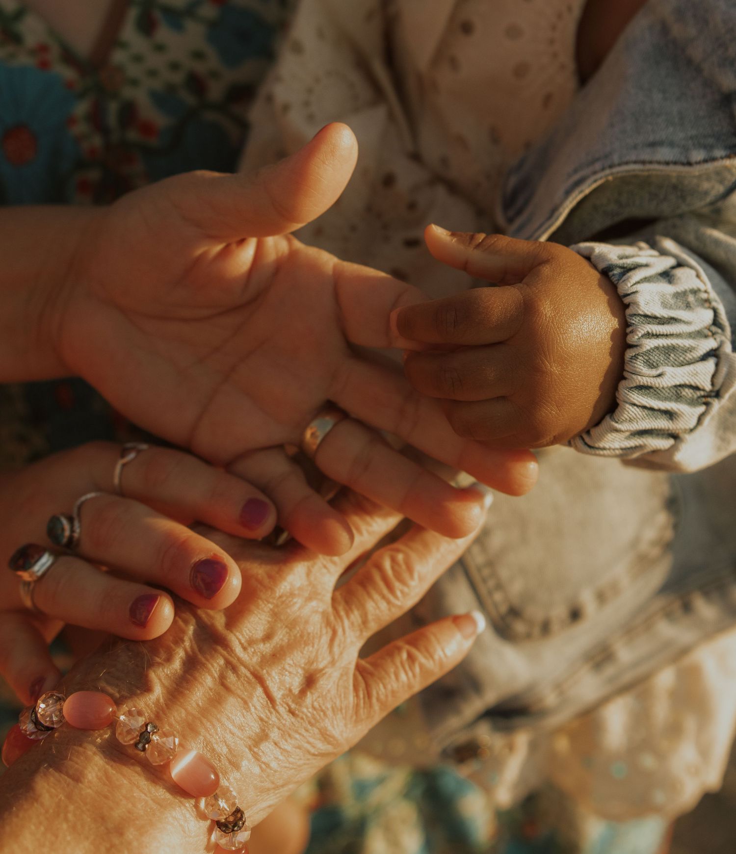 A sequence of hands massaging and applying pressure to another hand in warm lighting.