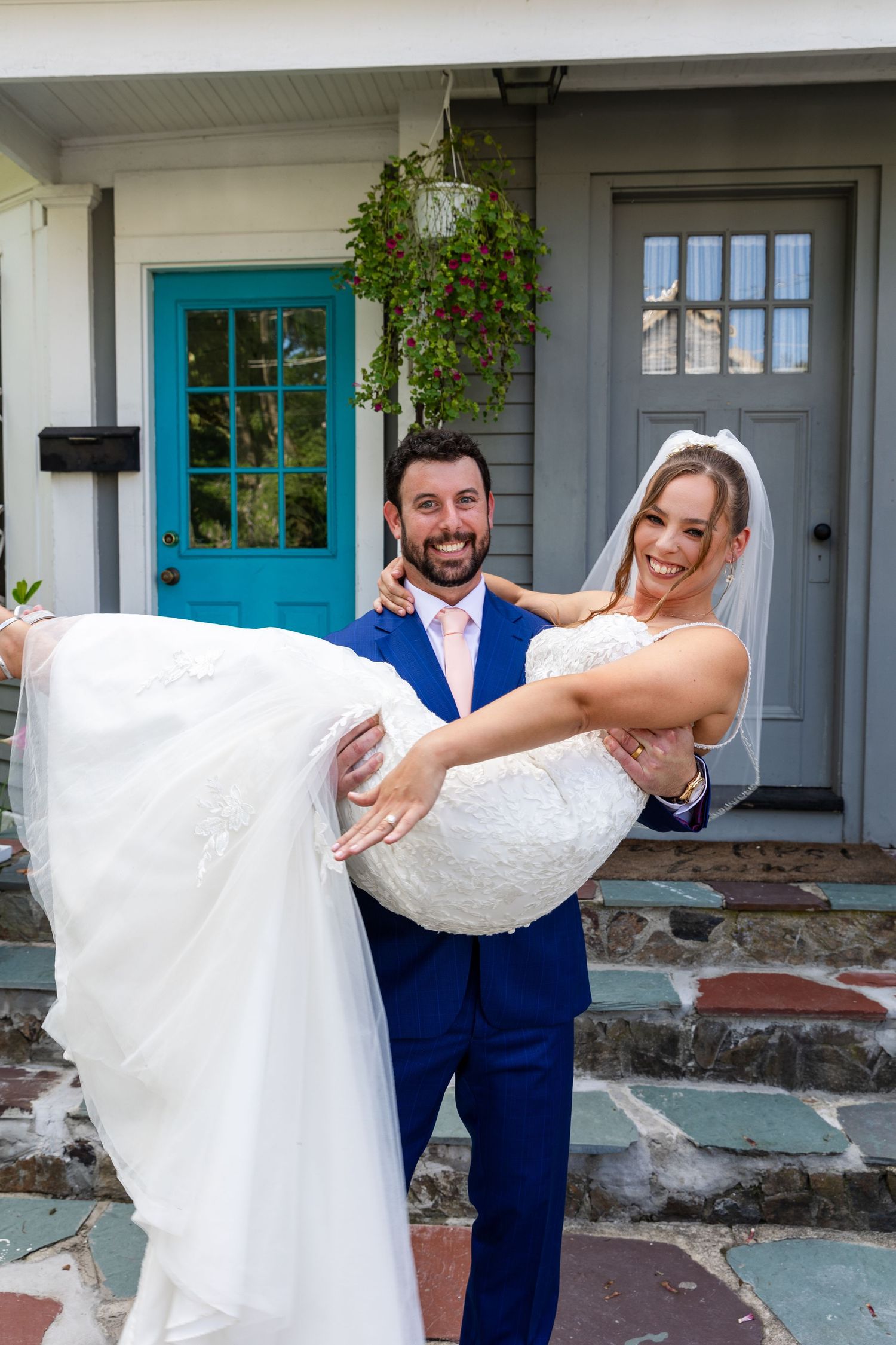 A romantic moment captured in a photo series showing a couple outside a home with turquoise trim windows.