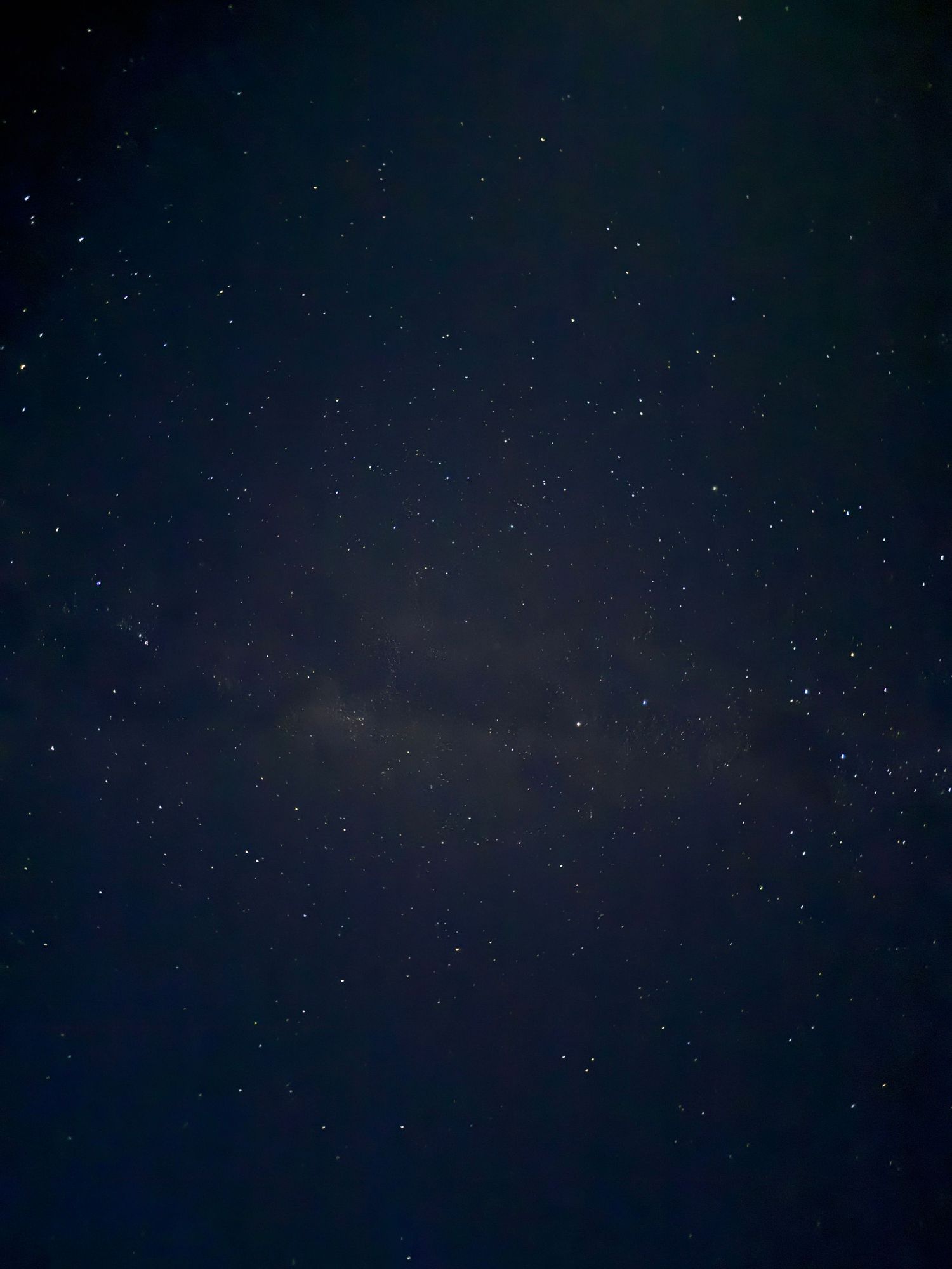 A time lapse photo series showing stars trails rotating across a dark night sky in curved patterns.