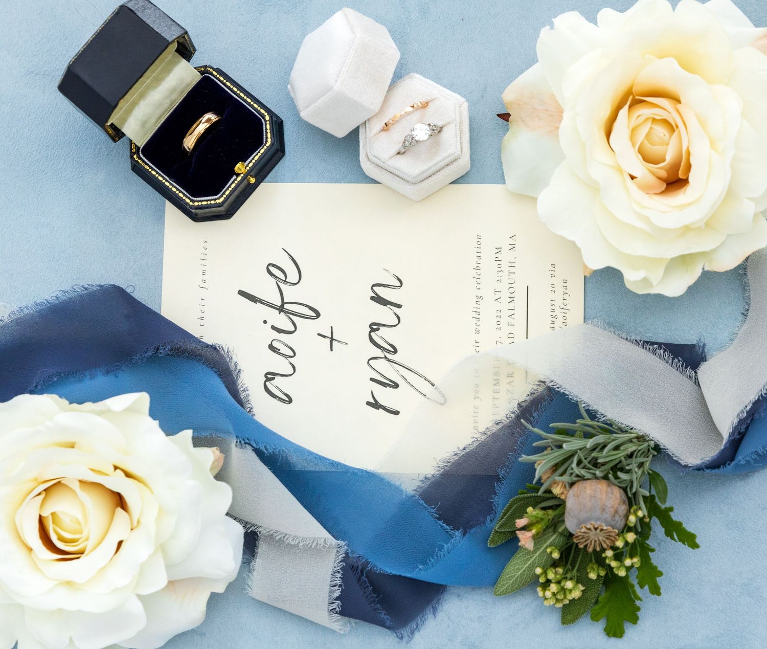 Romantic wedding invitation set in blue and white with roses, velvet wrap and delicate calligraphy details.