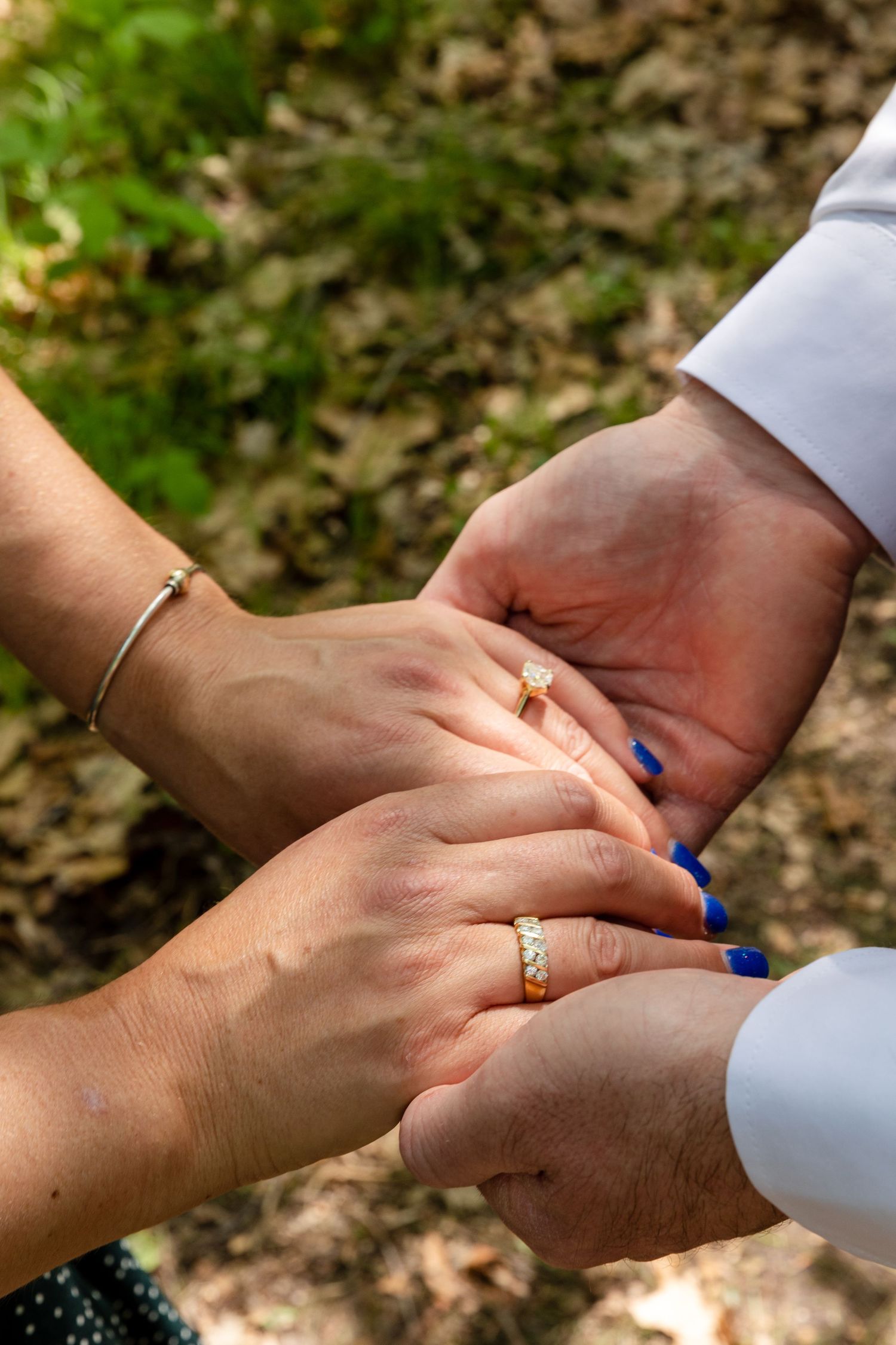 Four close-up photos showing hands with rings joining together in sequence, symbolizing a union or commitment.