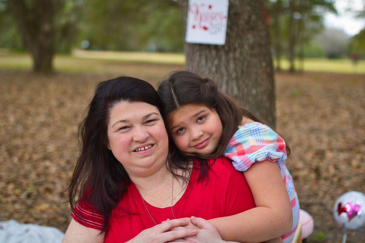 Heartwarming Valentine's themed outdoor photoshoot with decorative heart pillows.