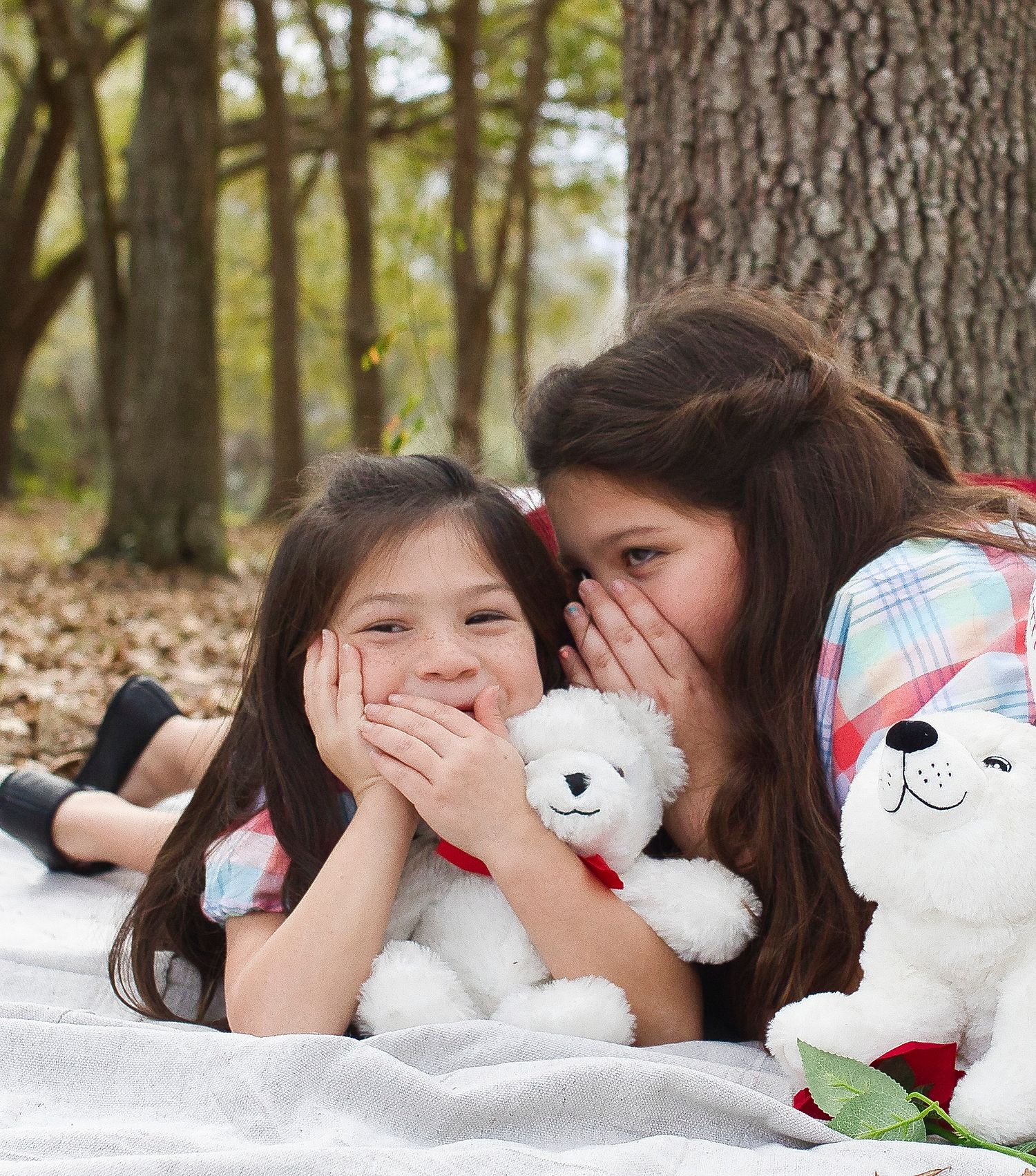 Playful moment with stuffed animals and heart pillows during Valentine's themed photo shoot.