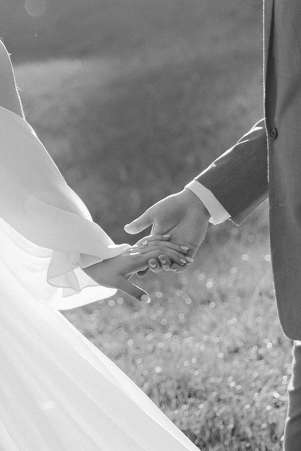 bride and groom holding hands