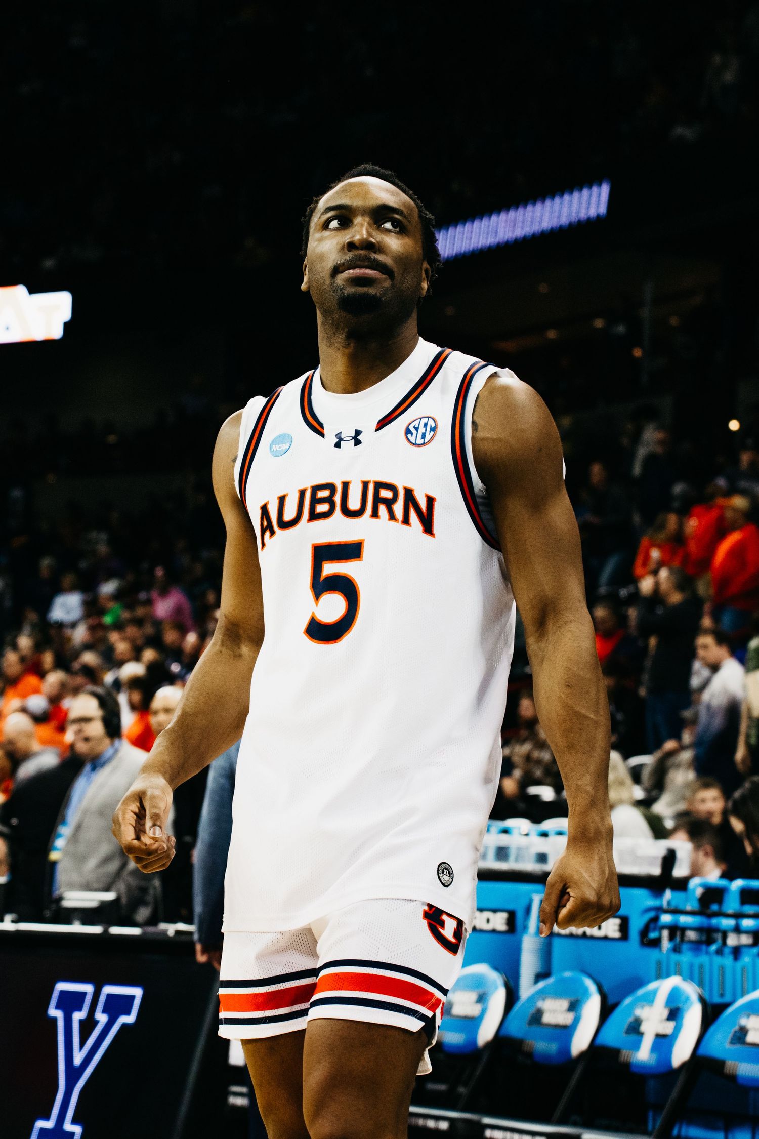 Auburn basketball player in white jersey number 5 stands on court during game.