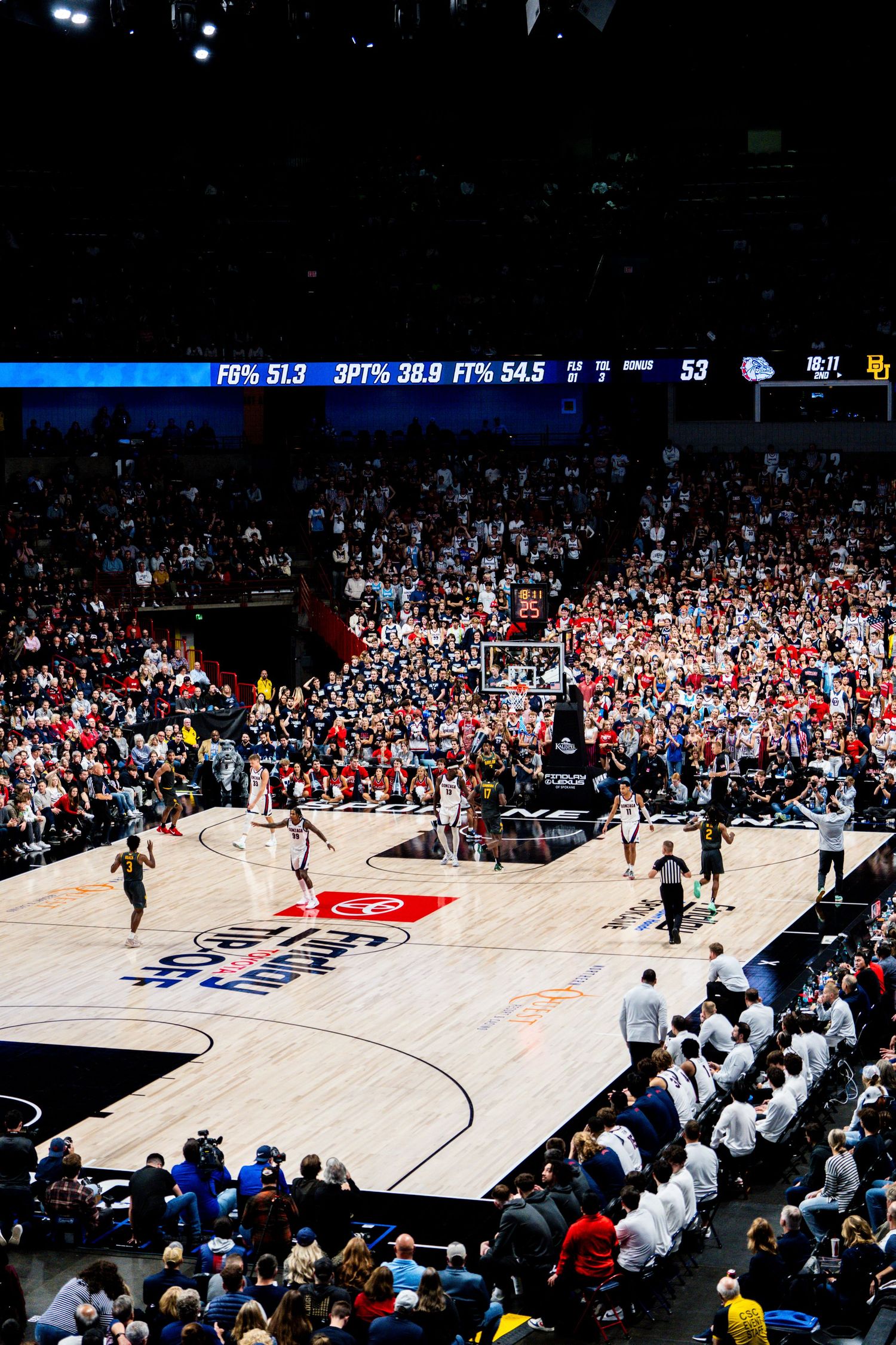 High-angle view of a professional basketball court during a game with crowded stands at NBA arena.