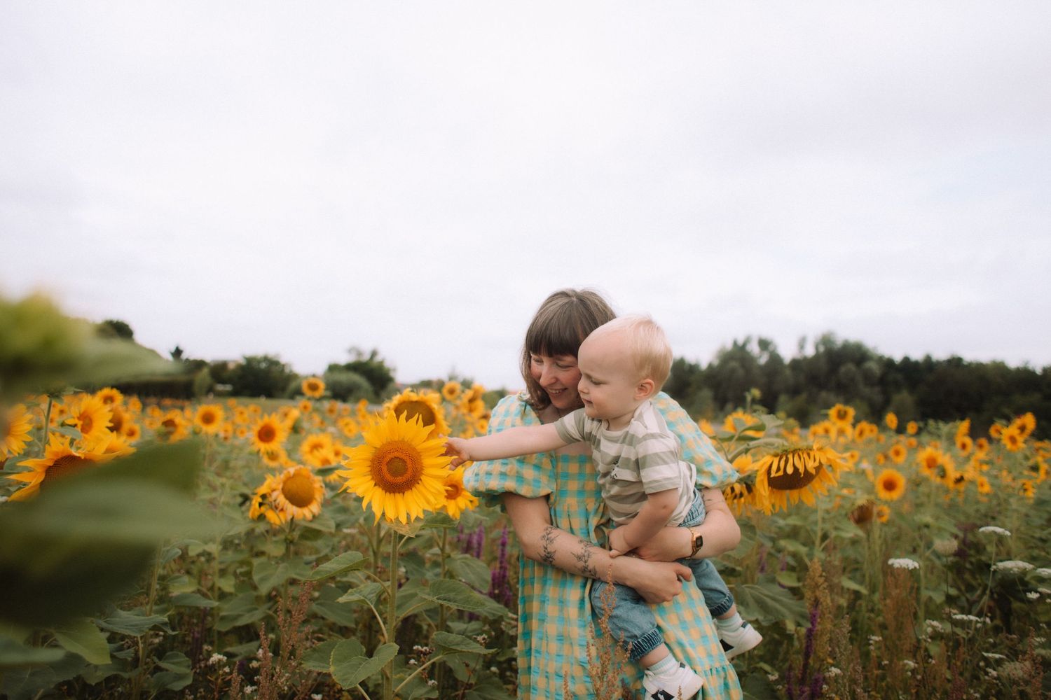 Mama en zoontje tussen de zonnebloemen