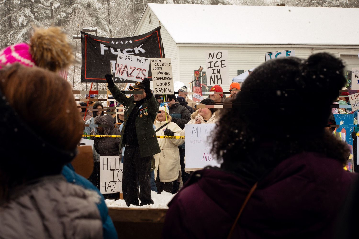 Veteran holding a sign that reads, 