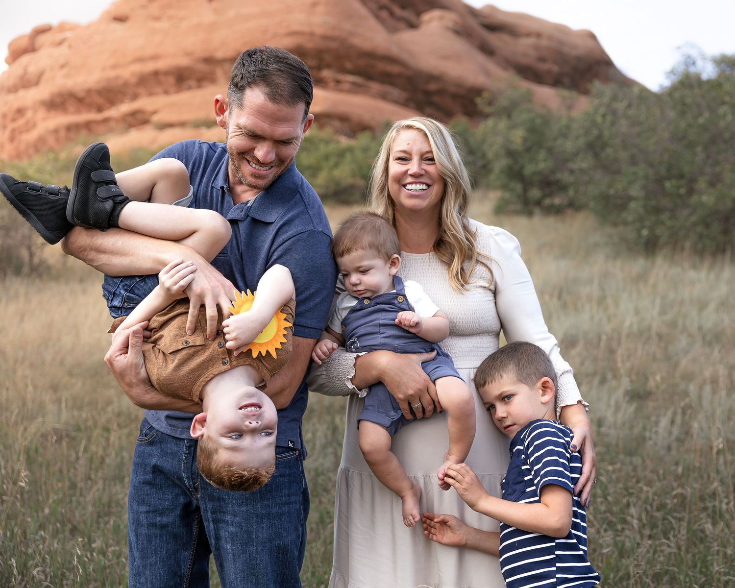 Family enjoying playful moments together in an outdoor setting.