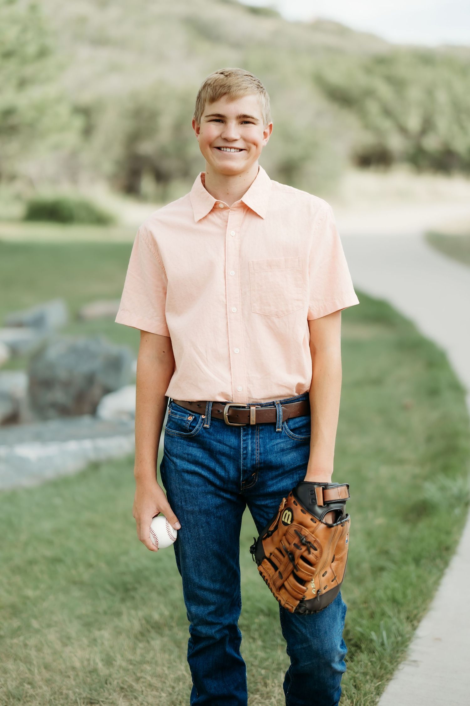 Casual summer outfit with baseball glove in outdoor setting.