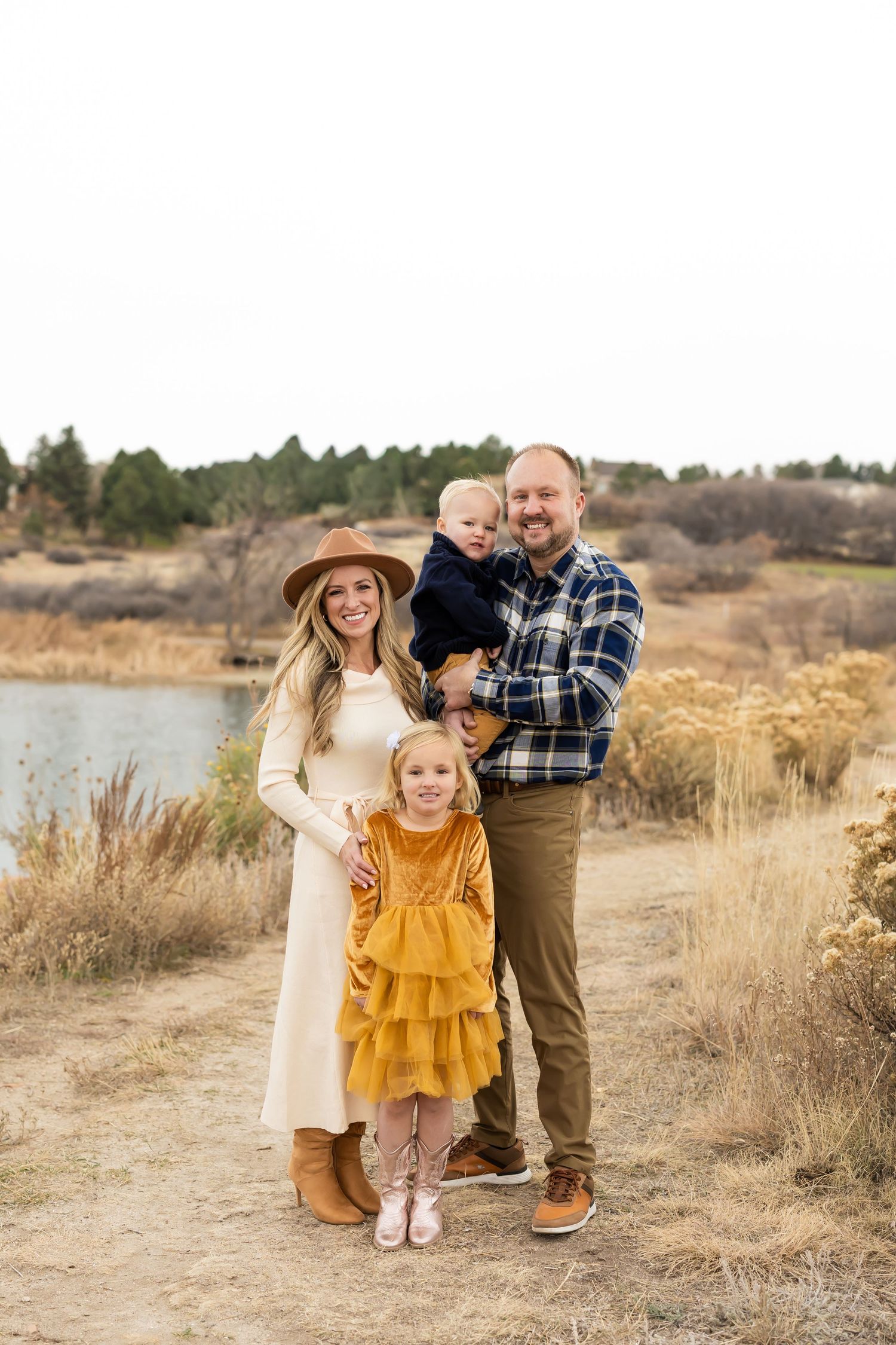 Outdoor family portrait session in a natural desert landscape during golden hour.