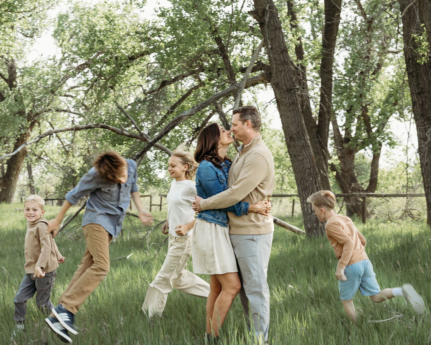 Candid family moments captured in a green park setting.