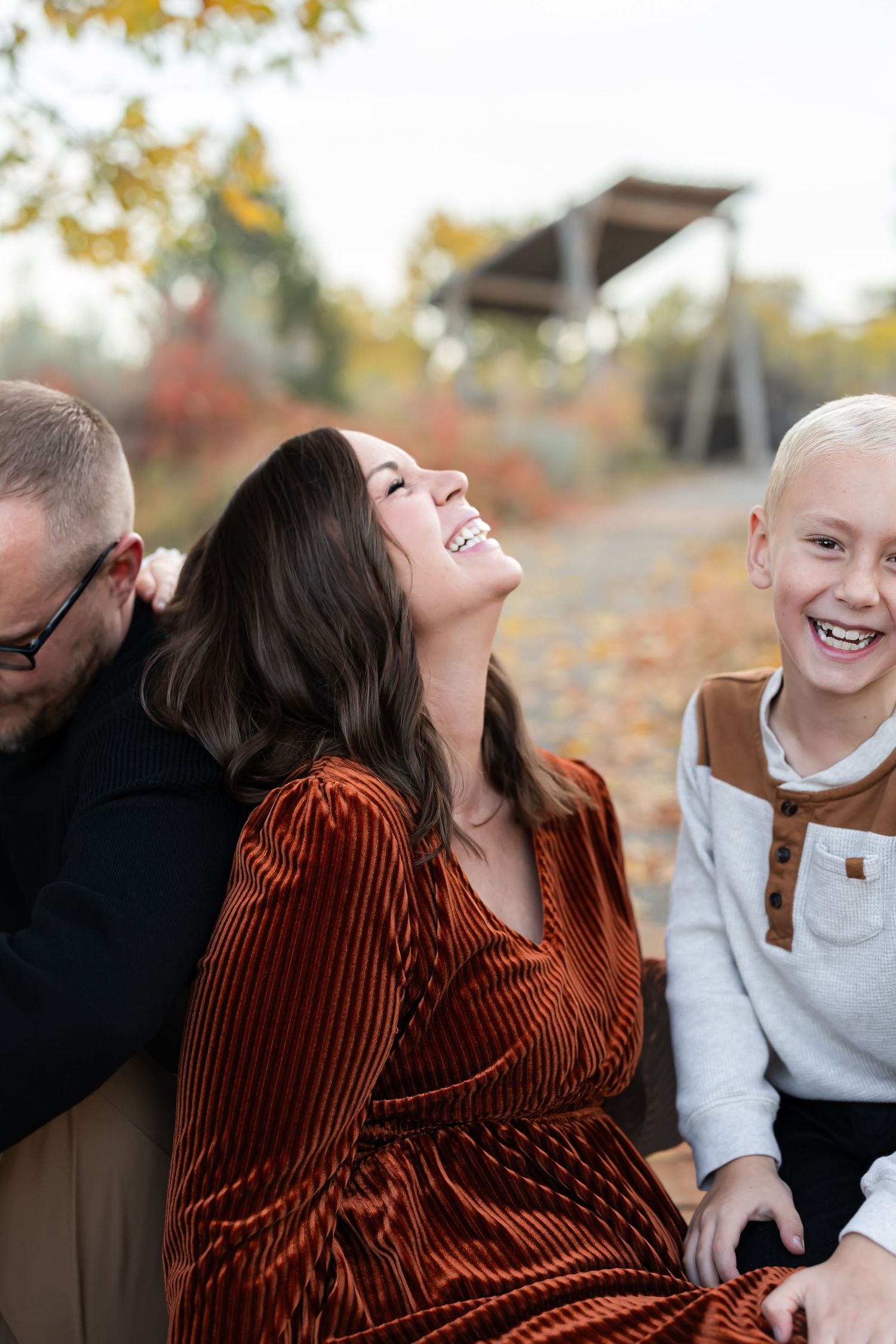 A candid photo series showing joyful laughter and natural interaction between two people during an autumn outdoor photoshoot.