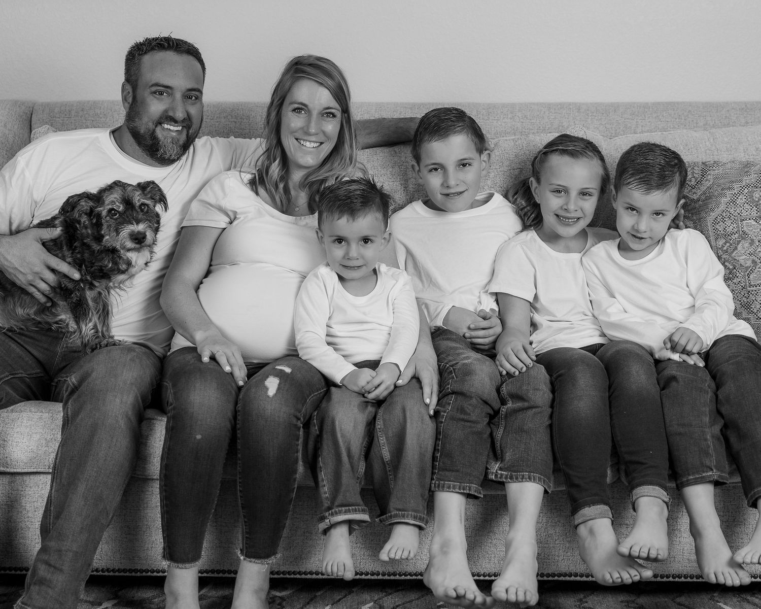 Black and white series of casual family photos showing feet dangling from a couch.
