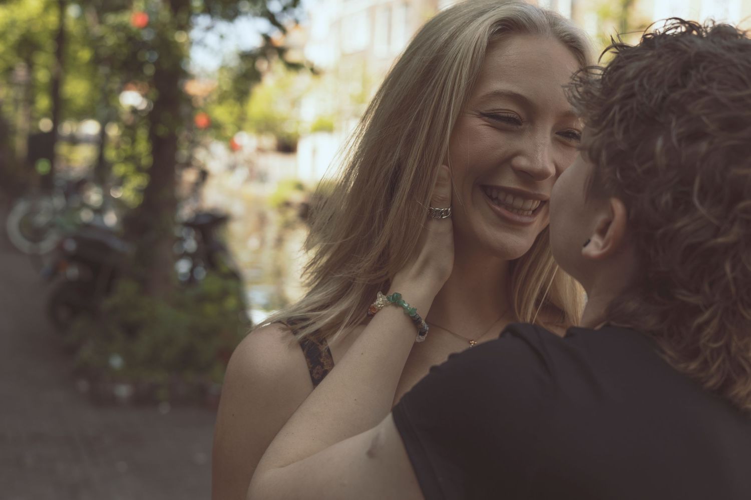 Candid couple laughter during relaxed outdoor photography session