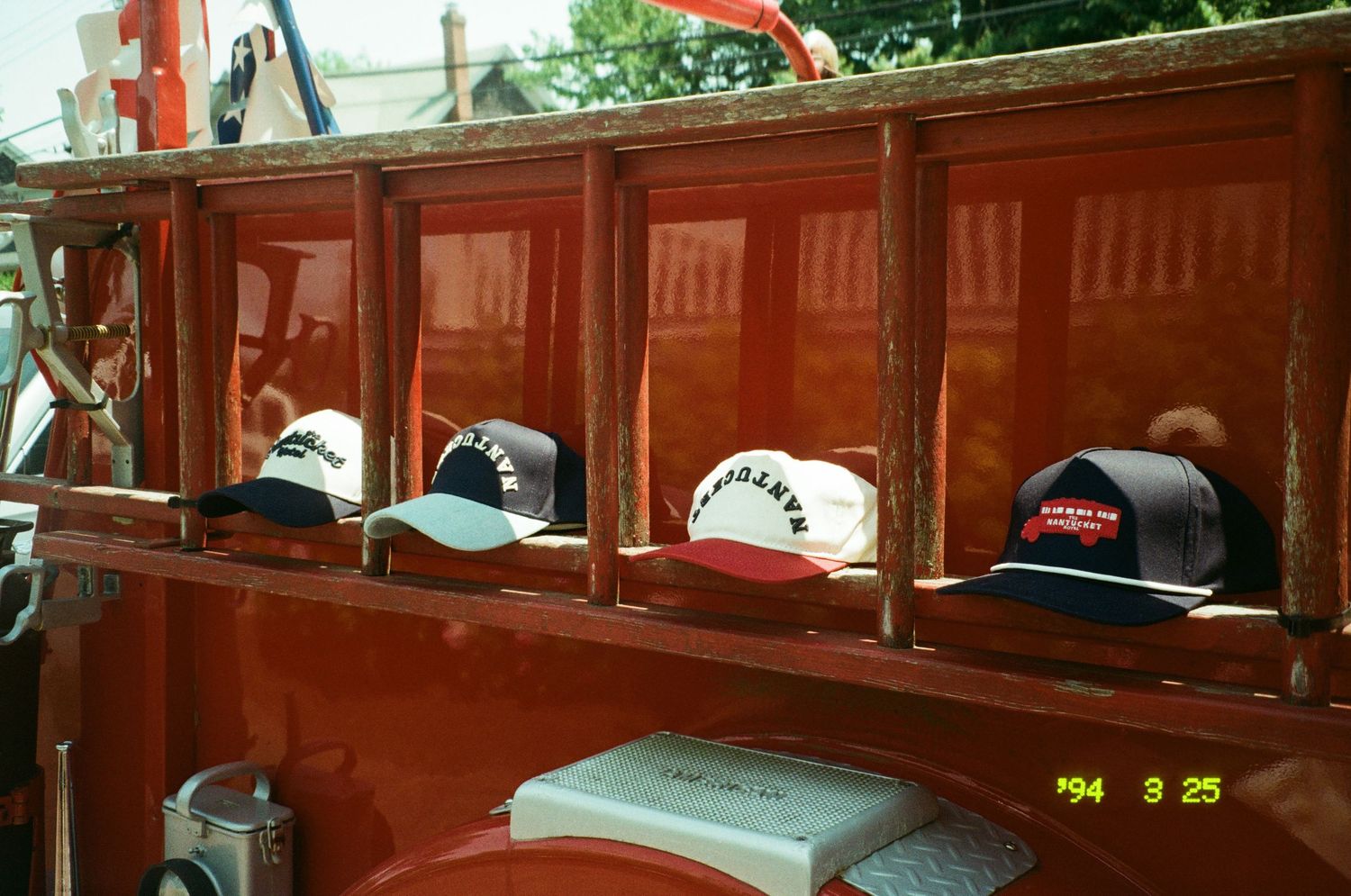 Nantucket Hotel hats aligned on a vintage fire engine