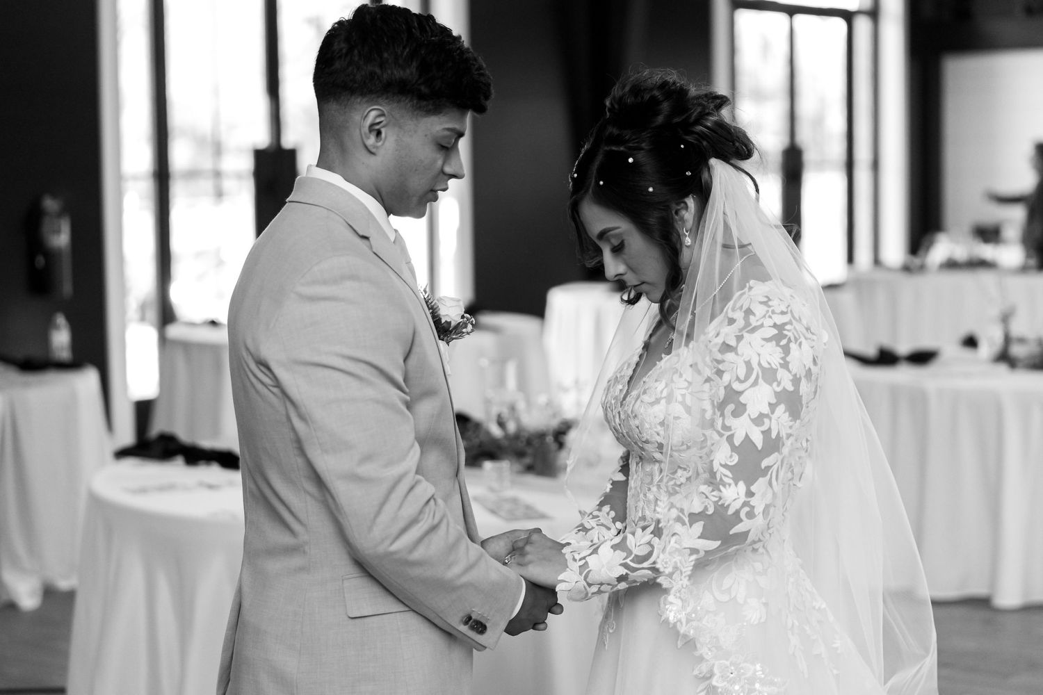 Black and white wedding ceremony moments captured in elegant indoor venue.