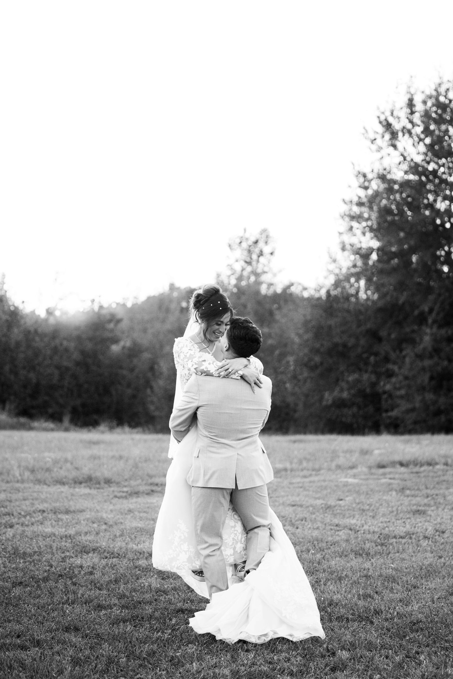 Black and white romantic wedding portraits in an open field.