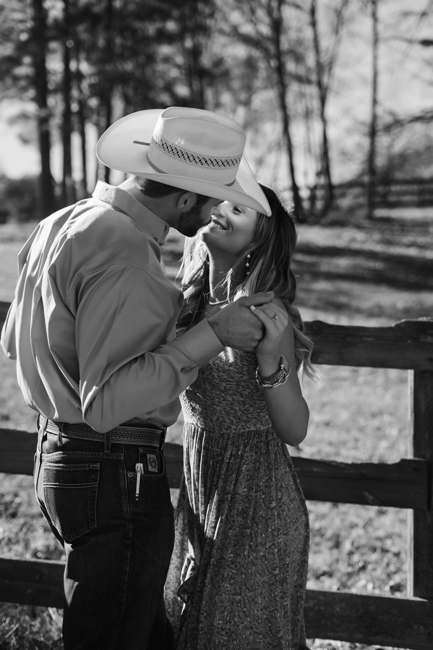 Vintage-style black and white photos of a couple by a wooden fence.