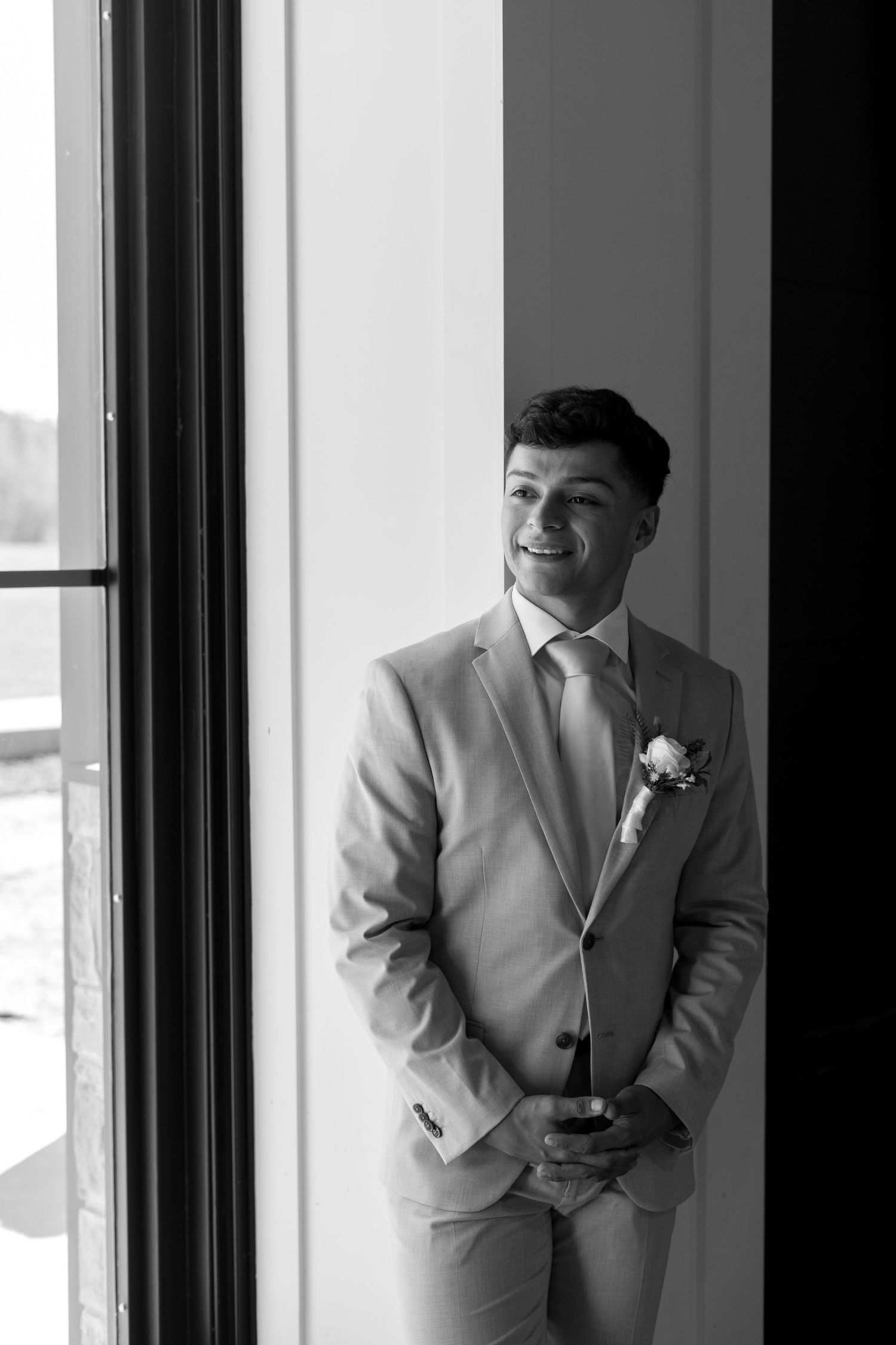 Black and white portrait showing silhouette against bright windows.