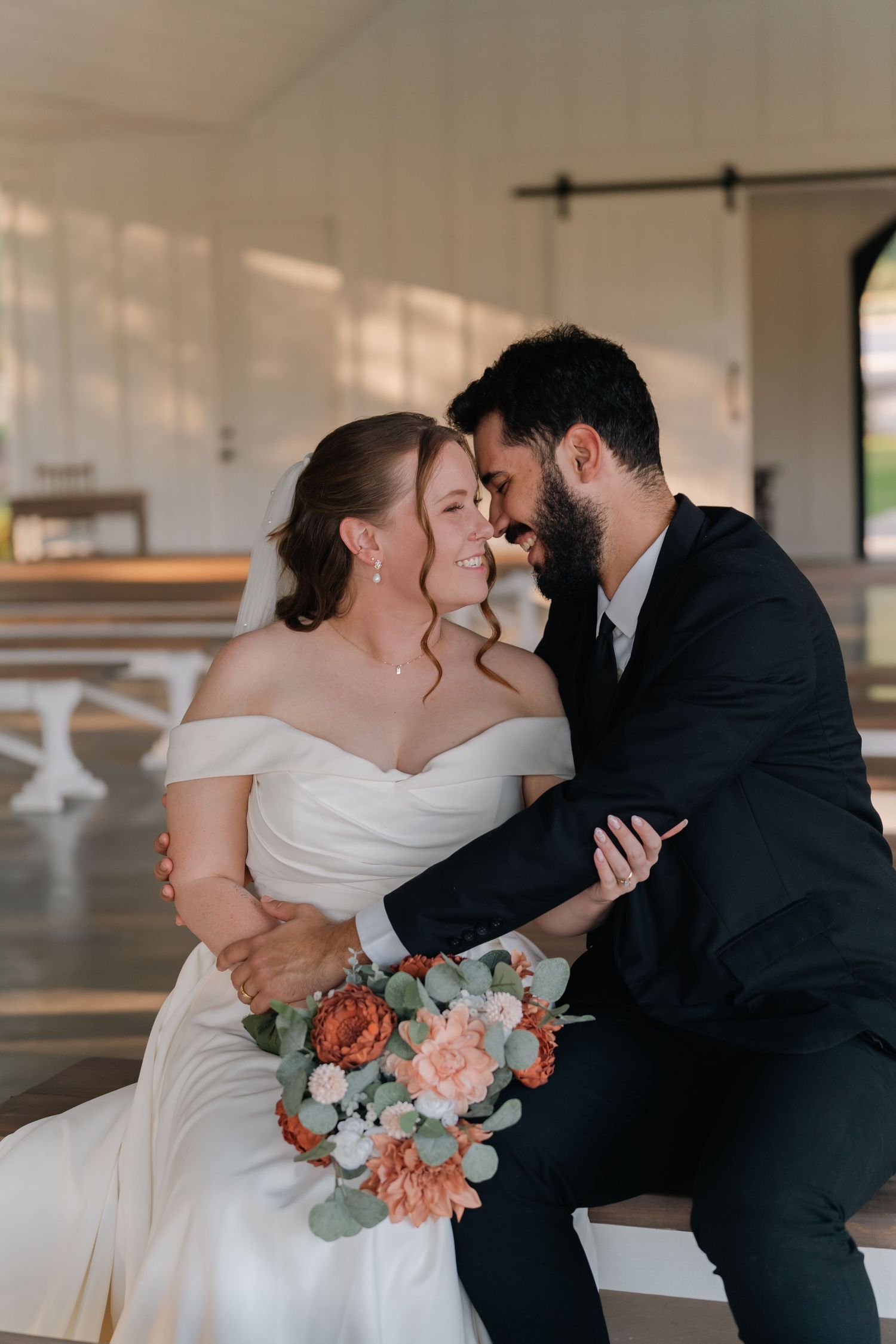 Romantic wedding couple sharing intimate kisses in a series of four elegant photos with a peach and white floral bouquet.