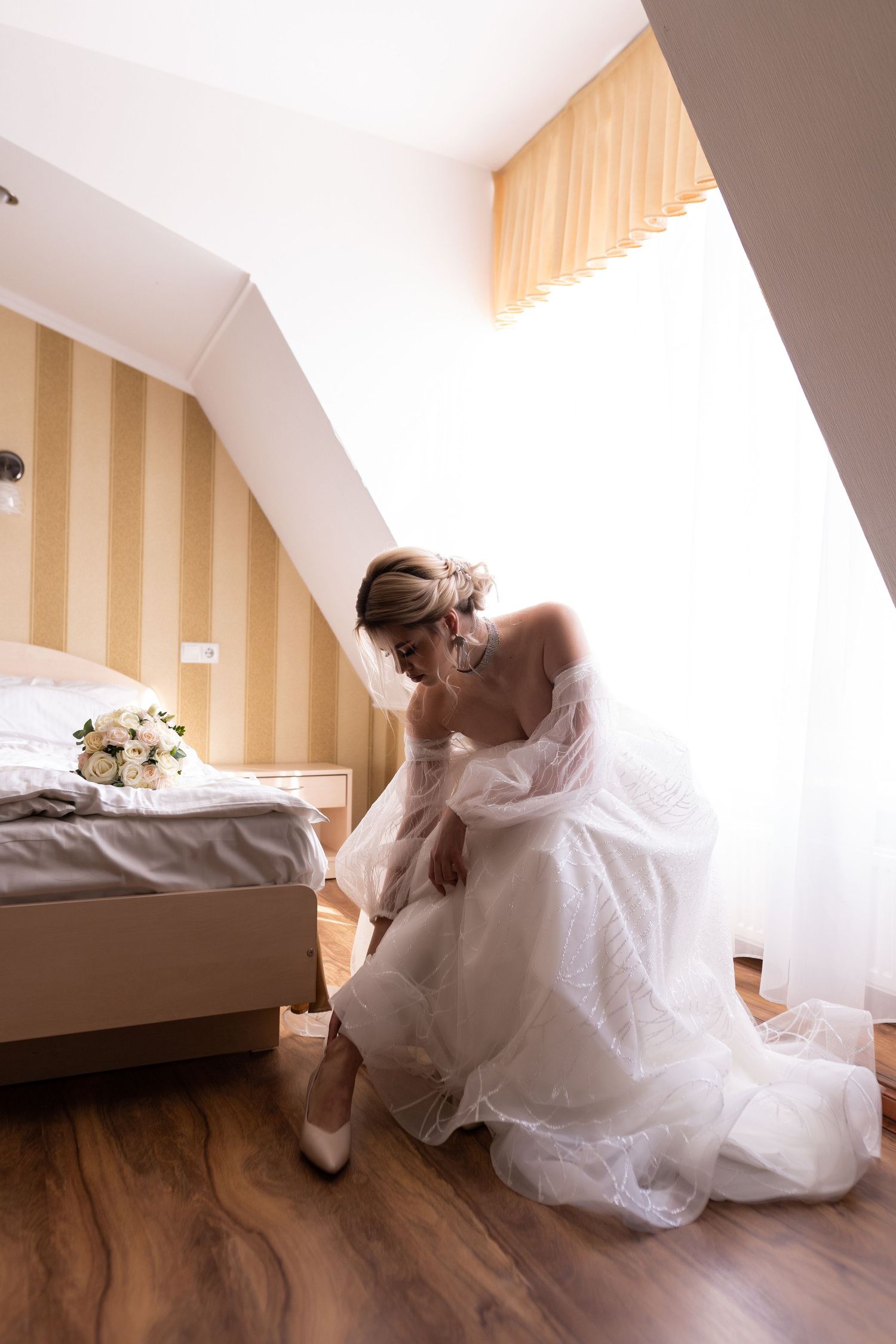 A sequence of five photos showing a person in a white wedding dress laying down on a hardwood floor.