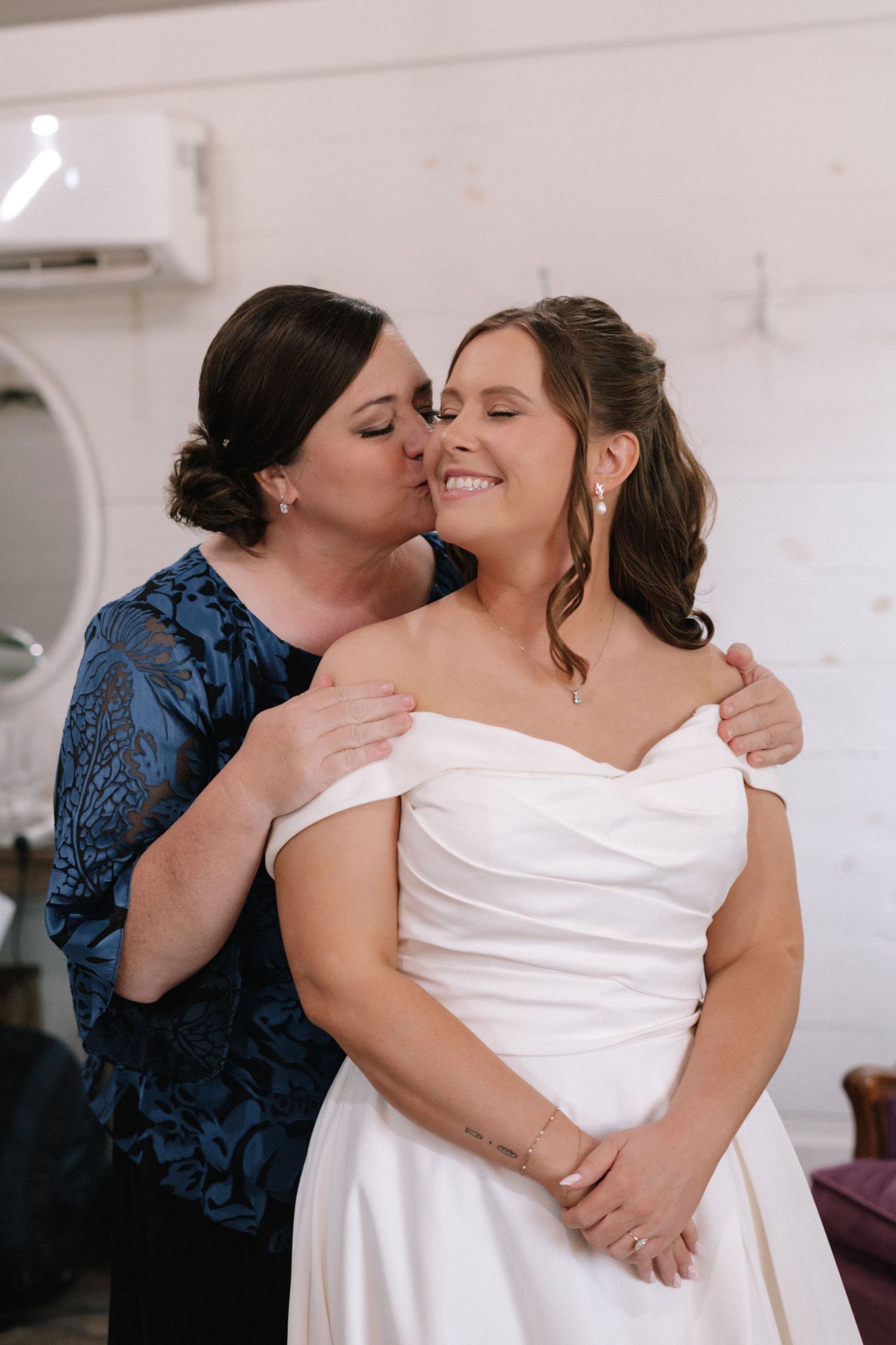 Emotional moment between two people in wedding attire sharing an embrace.