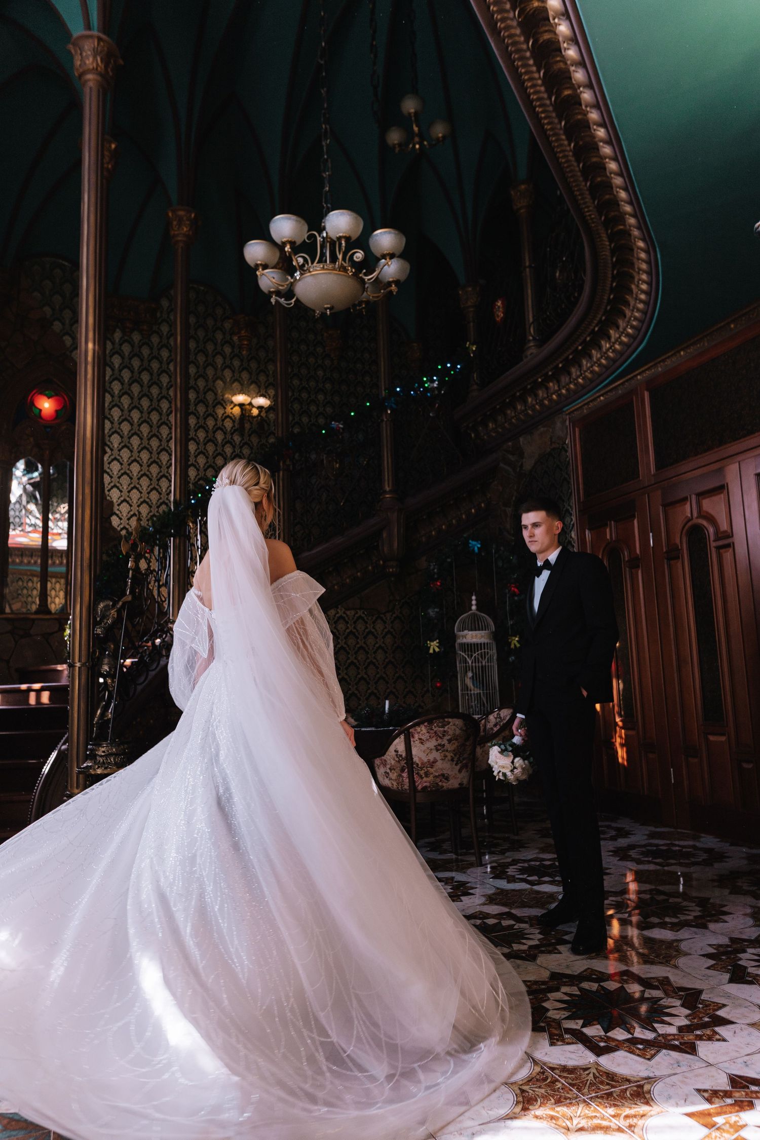 Elegant wedding scene in a grand ballroom with ornate architecture and dramatic lighting showcasing a flowing white gown.