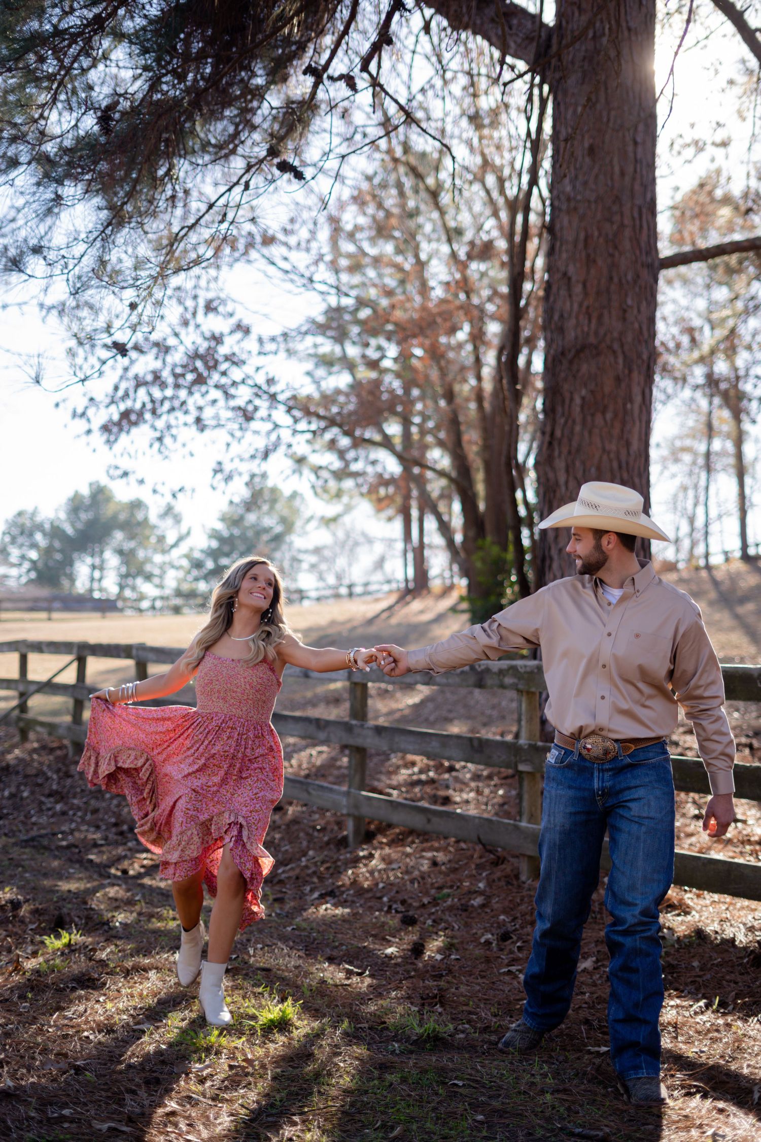 Dancing and twirling photos captured in a rustic outdoor setting with pine trees.
