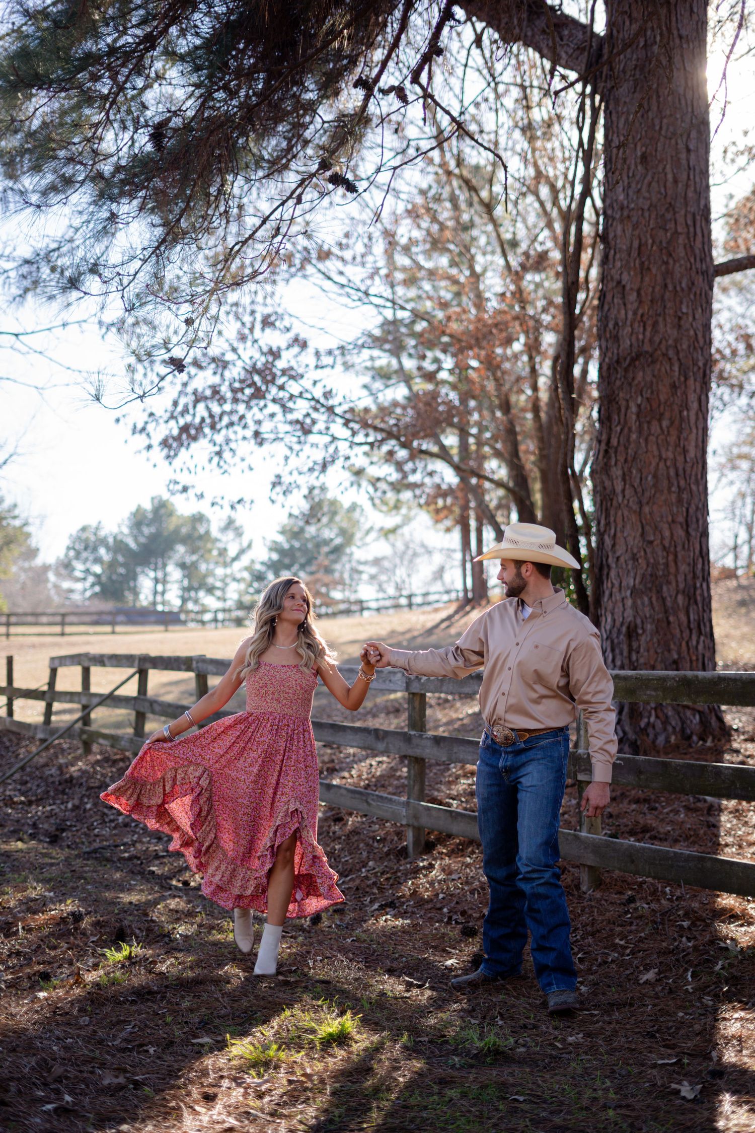 Playful outdoor photoshoot among pine trees with rustic country styling.