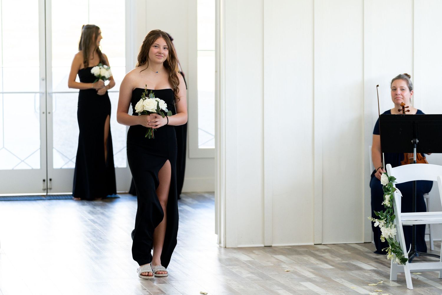 A series of candid moments from a wedding celebration showing guests mingling in a bright white venue.