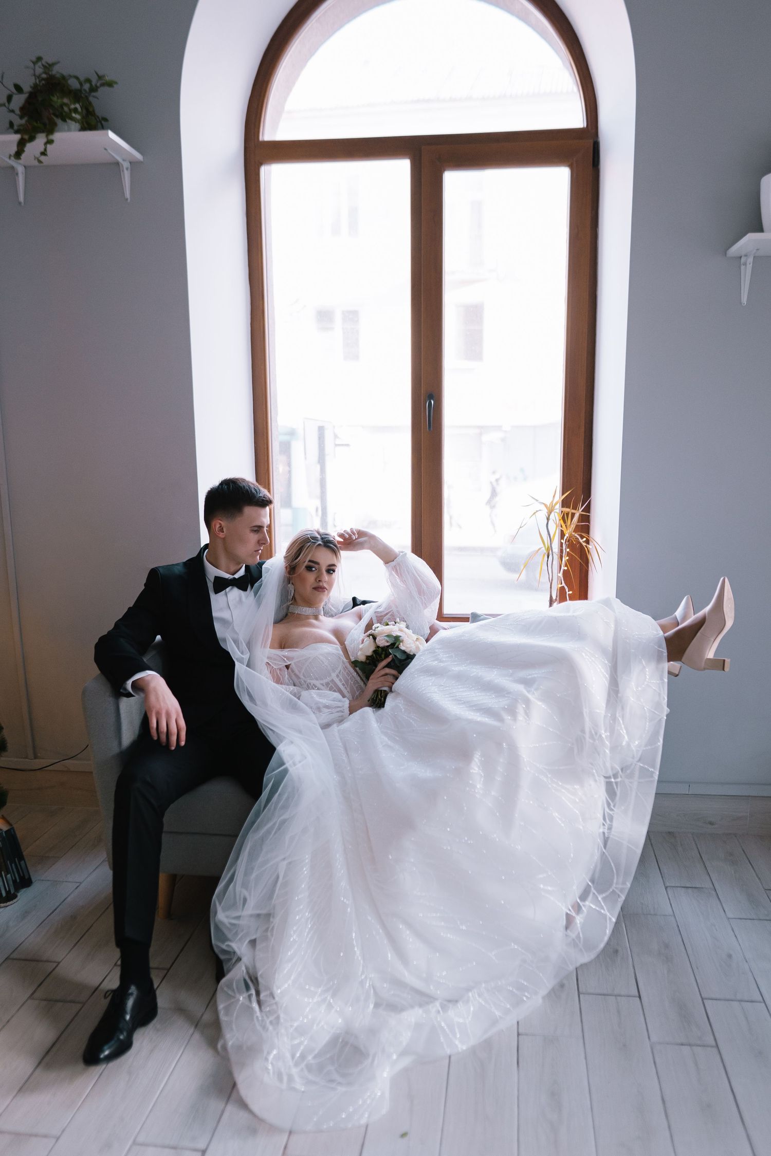 A romantic wedding dance sequence showing flowing white dress movements across a light wood floor in an elegant room.