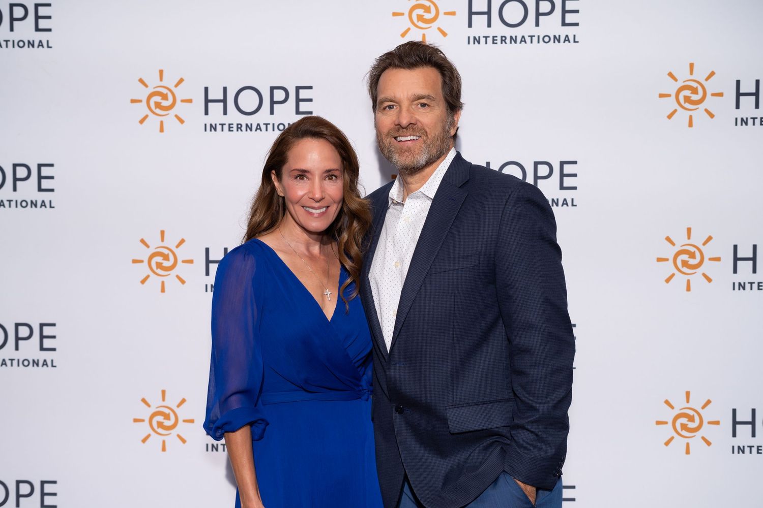 Event backdrop with HOPE International branding and logo repeated in step-and-repeat pattern.