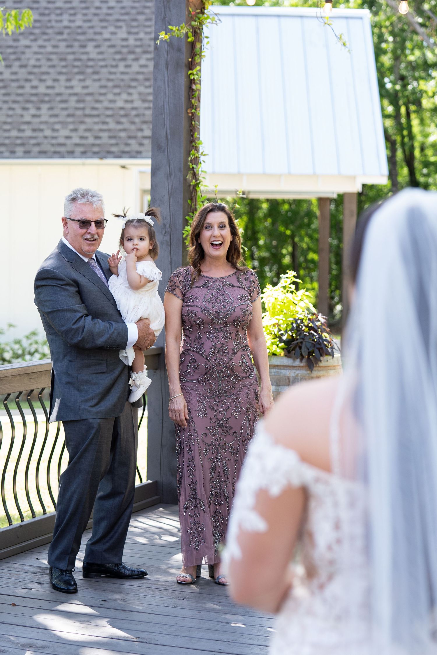 A series of candid wedding photos showing guests interacting on an outdoor deck during a celebration.