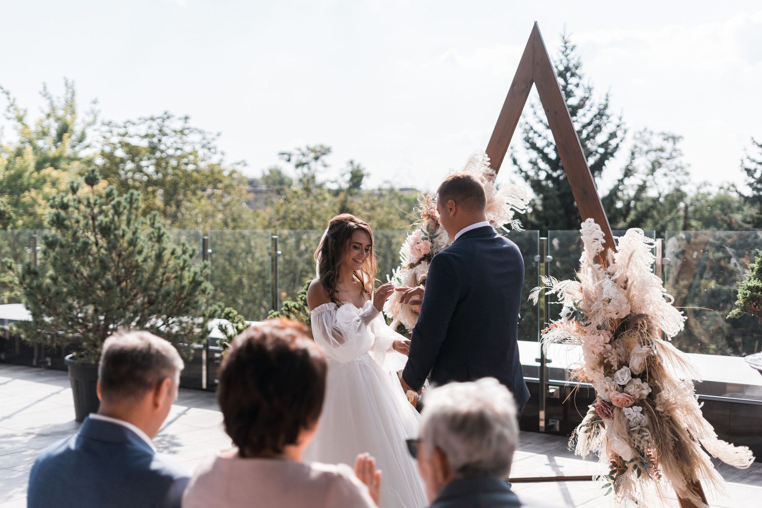 A series of candid outdoor wedding moments showing couples embracing during a sunset celebration.